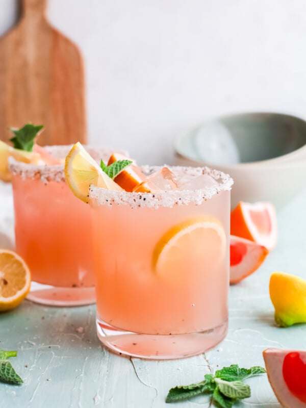 Grapefruit Paloma Cocktail with lemon wedges.