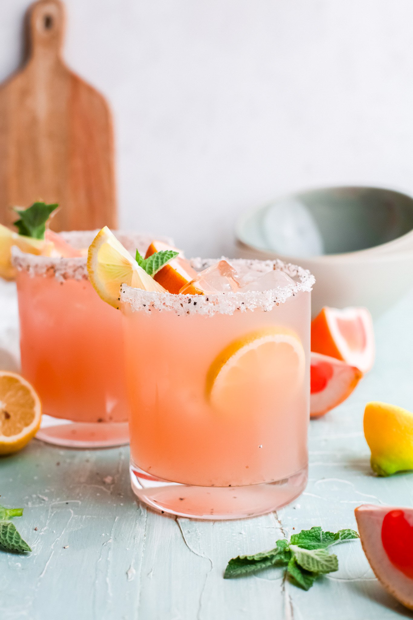 Grapefruit Paloma Cocktail with lemon wedges.