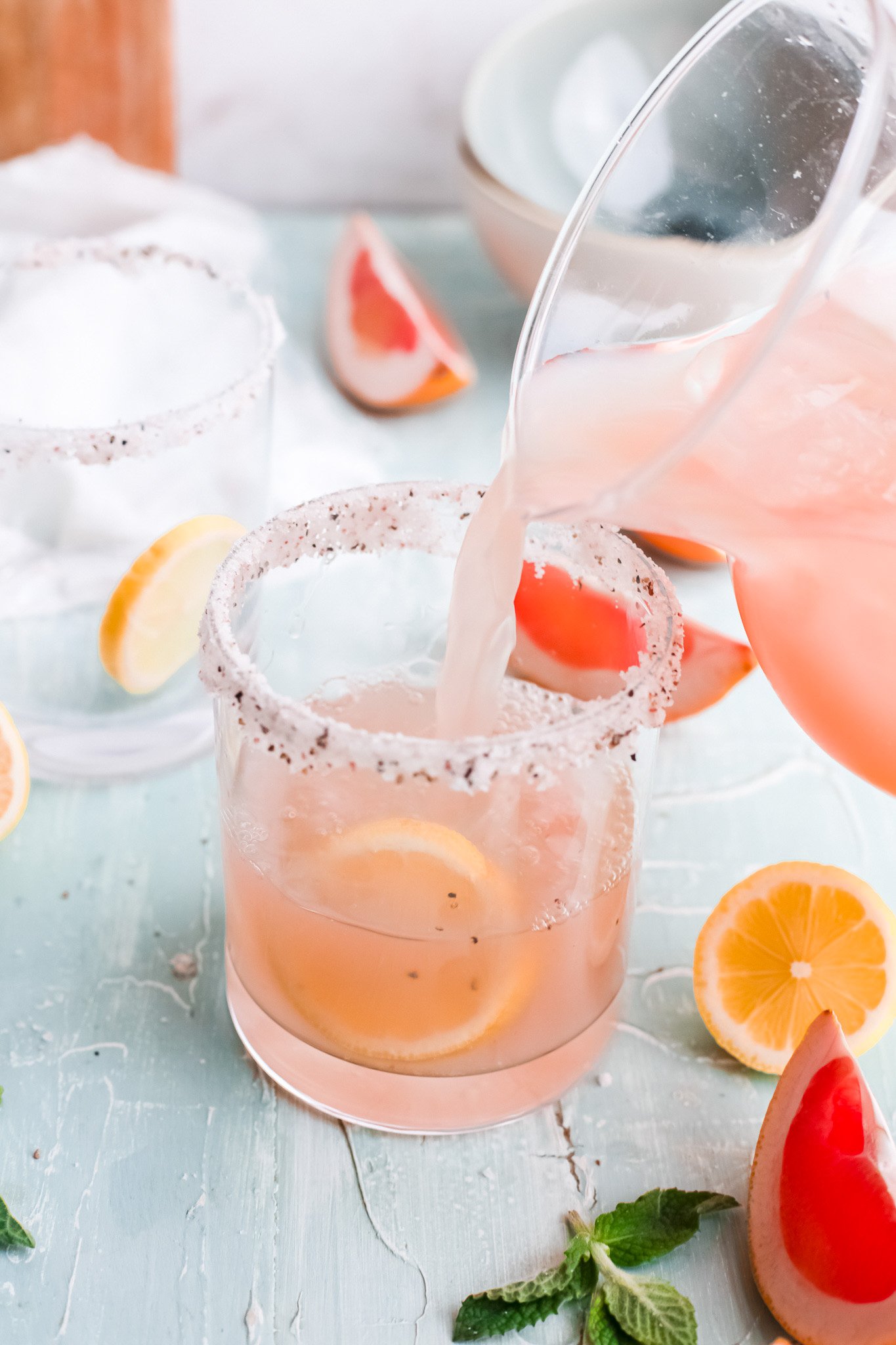 Grapefruit Paloma Cocktail pouring the paloma into a glass.