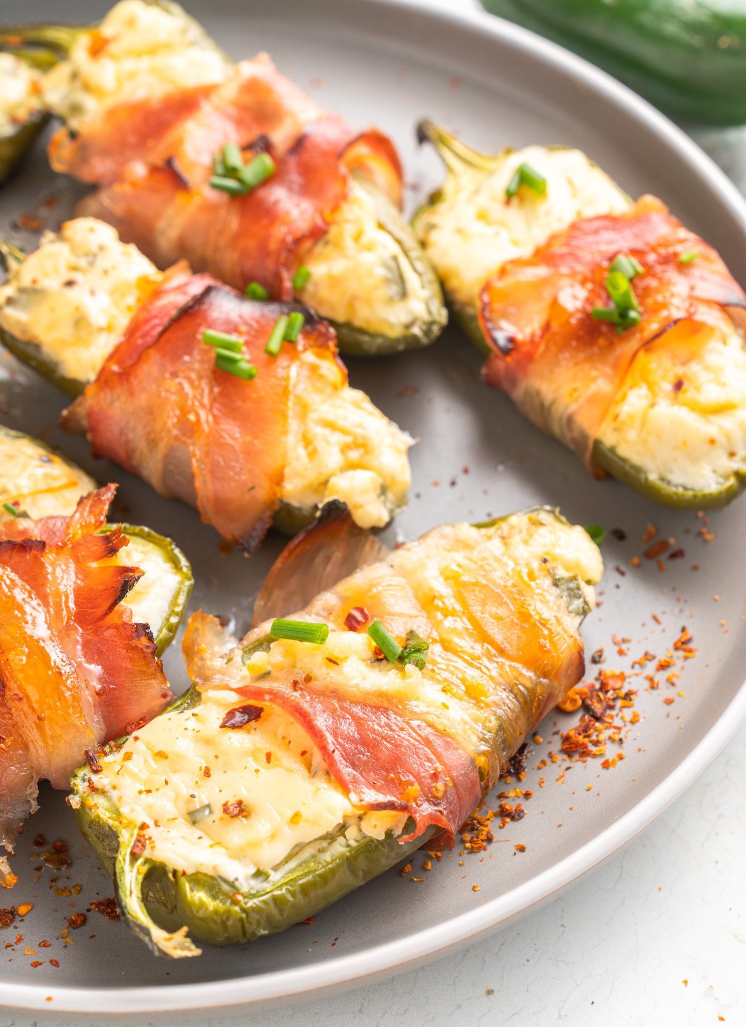 Jalapeño Poppers with Bacon on a round plate. 