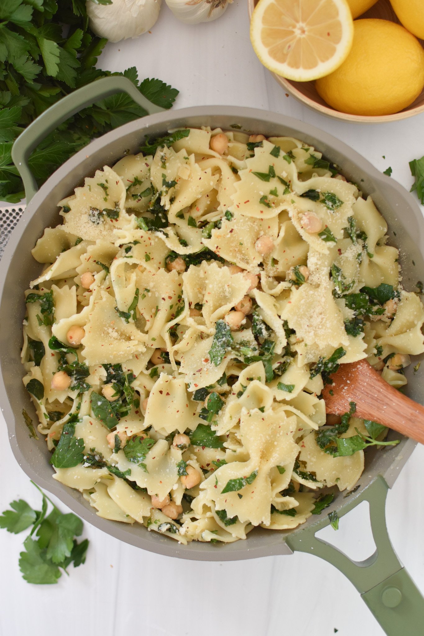 Cheesy Kale Pasta without the cheese and a spoon in the pasta. 