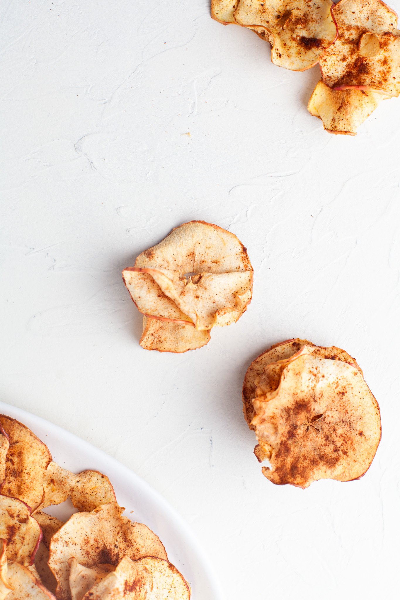 Easy Air Fryer Apple Chips apples on a table.