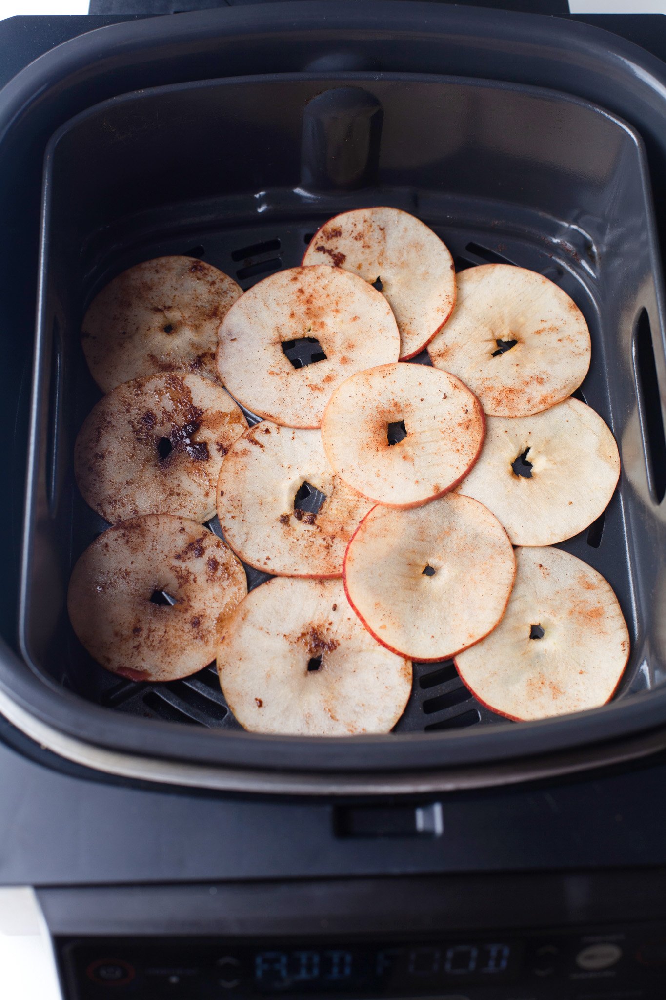 Easy Air Fryer Apple Chips apples in an air fryer.
