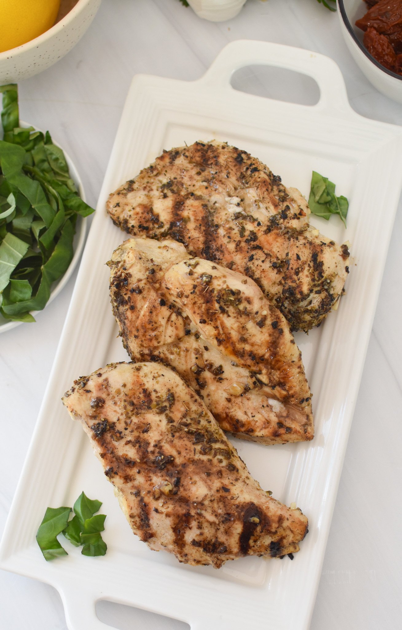 Chicken Bryan grilled chicken on a white plate. 