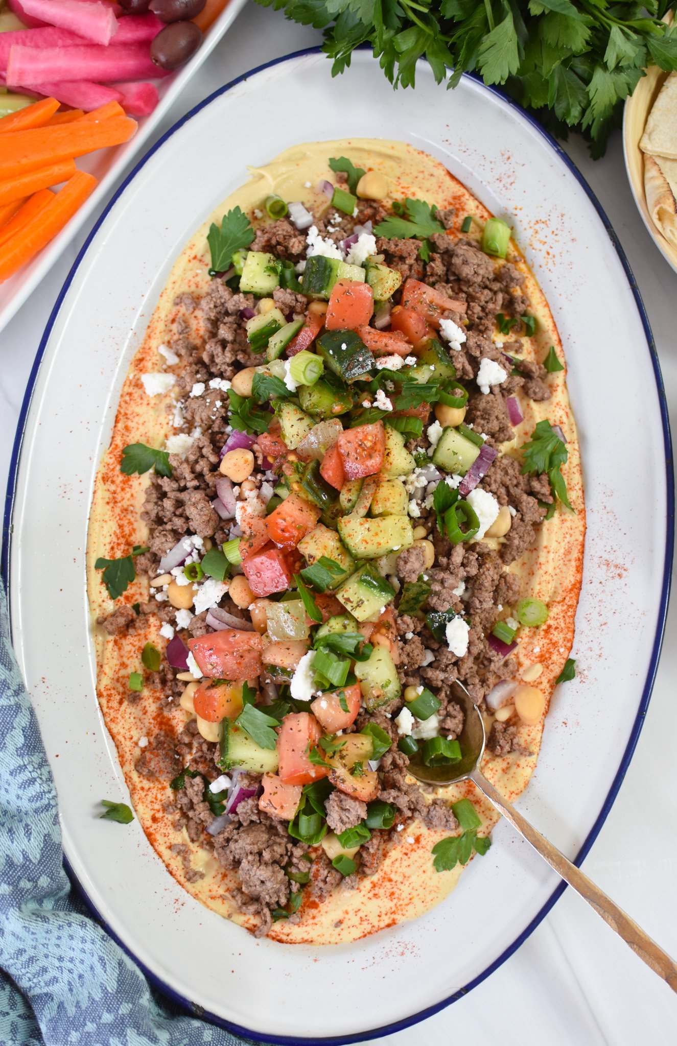 Ground Beef Layered Hummus with a spoon.