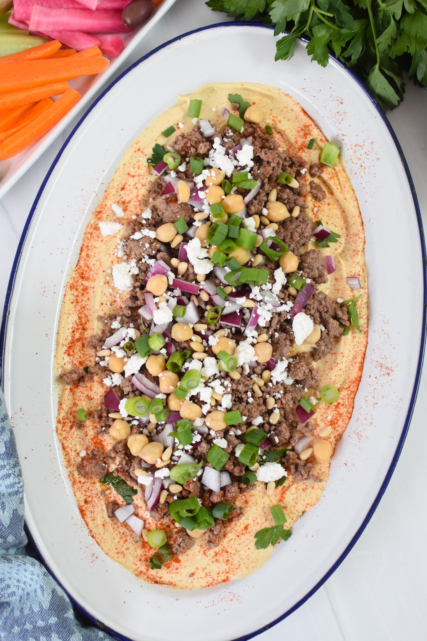 Ground Beef Layered Hummus with onions and parsley. 