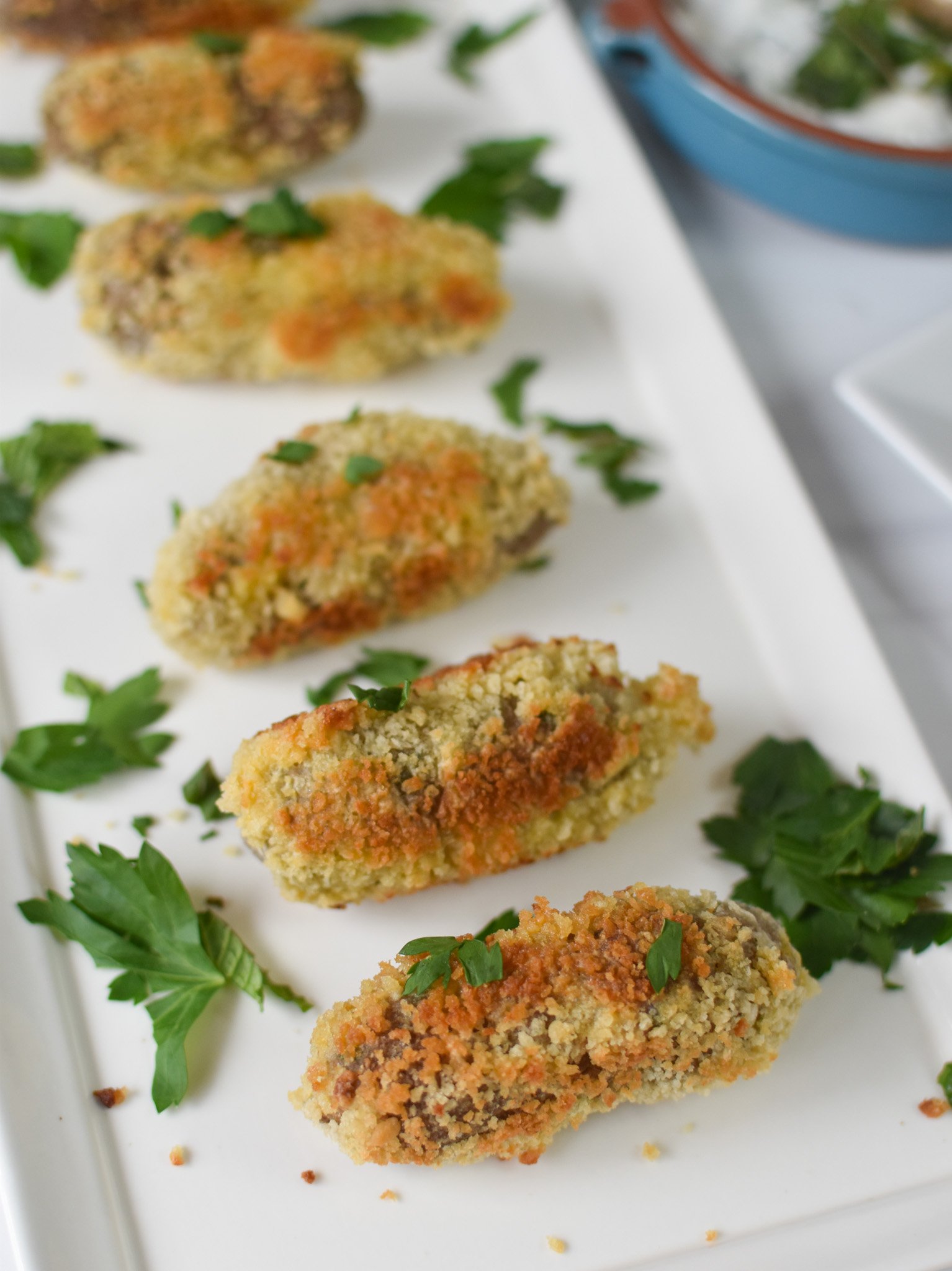 Lamb Croquettes on a white plate. 