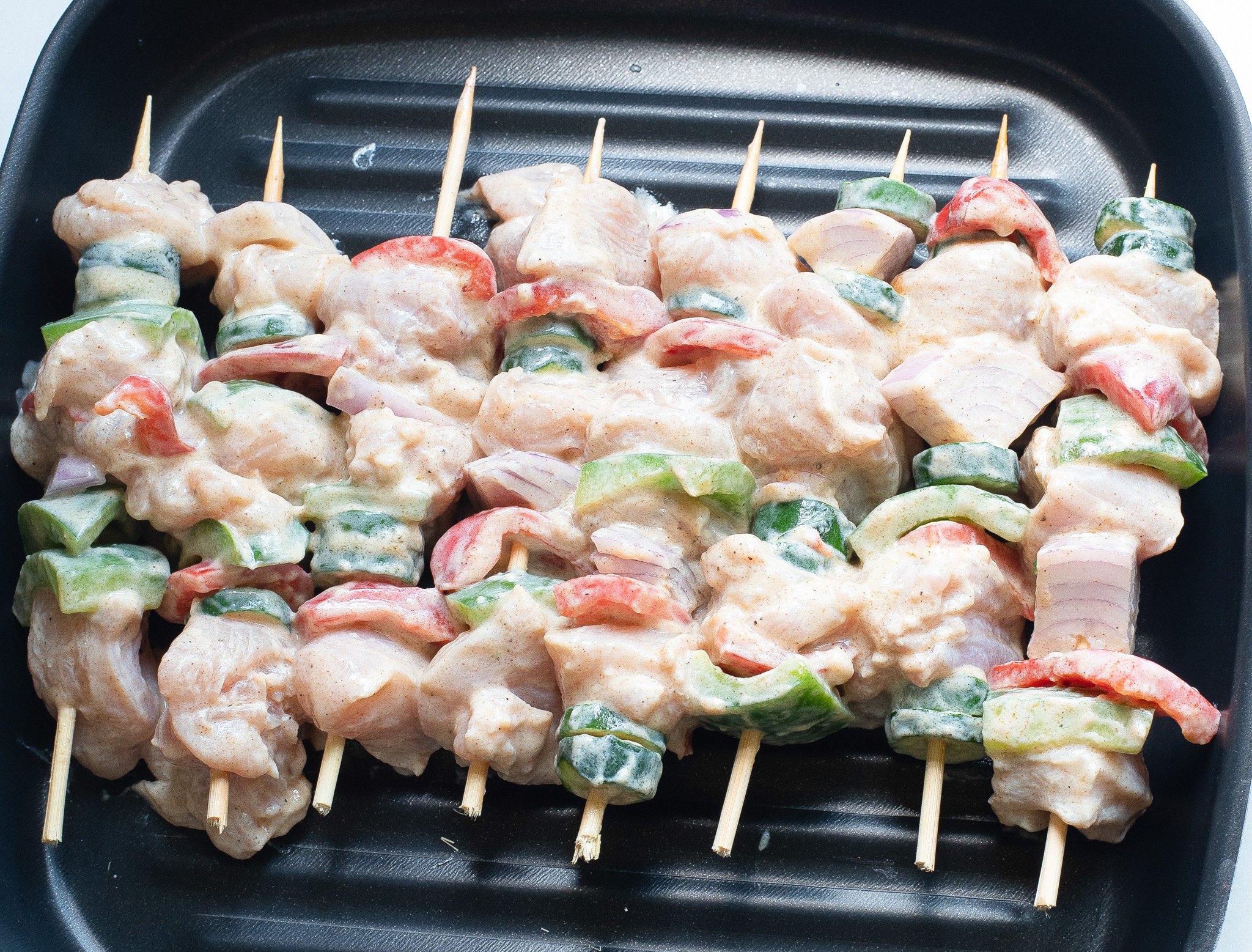 Greek Marinated Chicken Kabobs with Lemon on the grill. 
