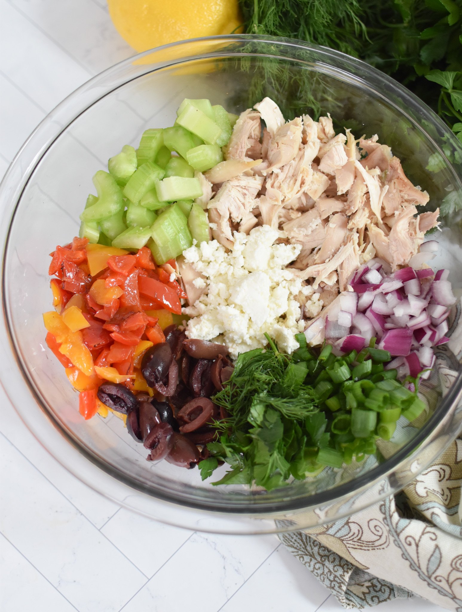 Healthy Mediterranean Chicken Salad ingredients in a bowl. 