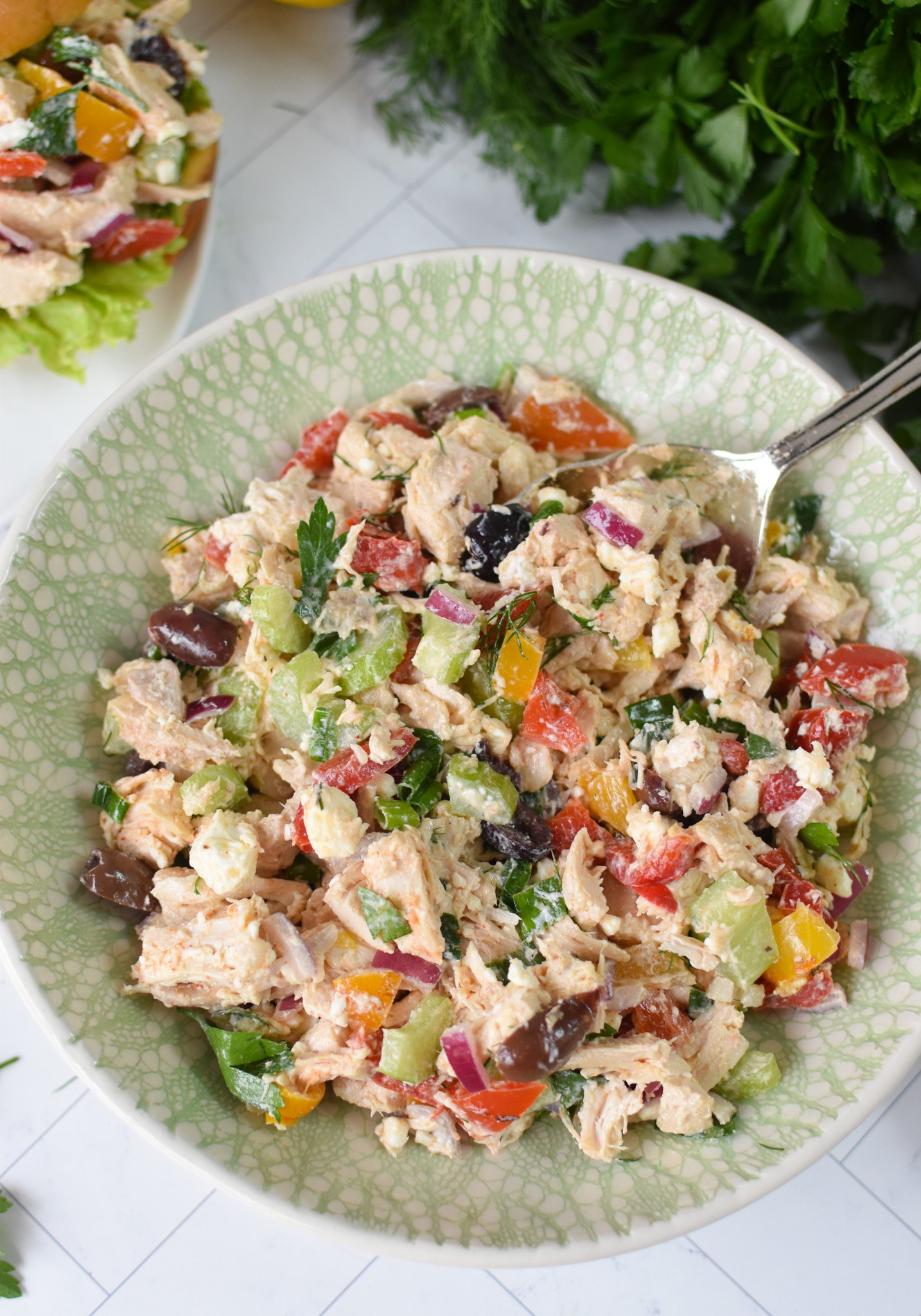 Healthy Mediterranean Chicken Salad in a green bowl. 