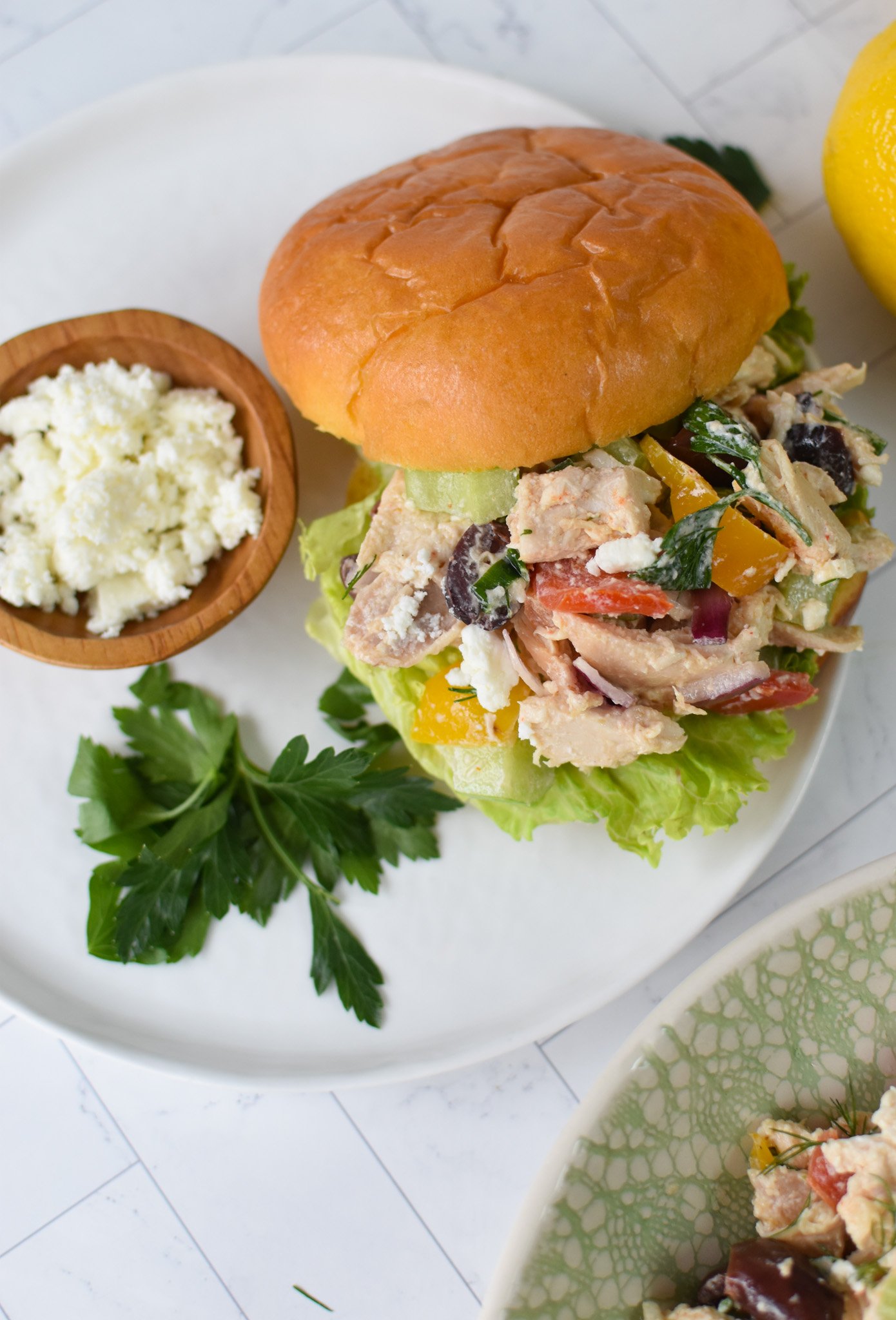 Healthy Mediterranean Chicken Salad on a bun.