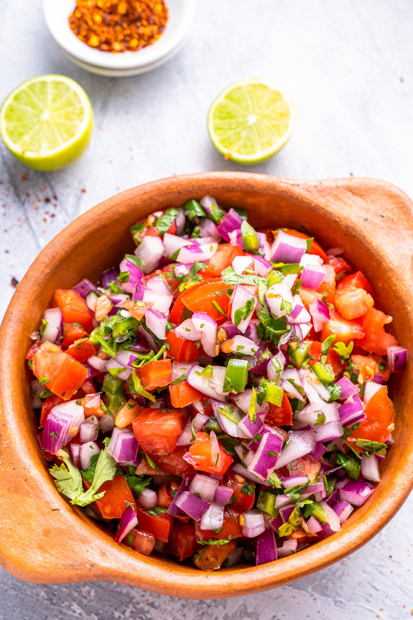 Homemade Pico de Gallo in a tan colored bowl. 