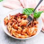 Sun-Dried Tomato Pesto Pasta with a fork in a bowl.