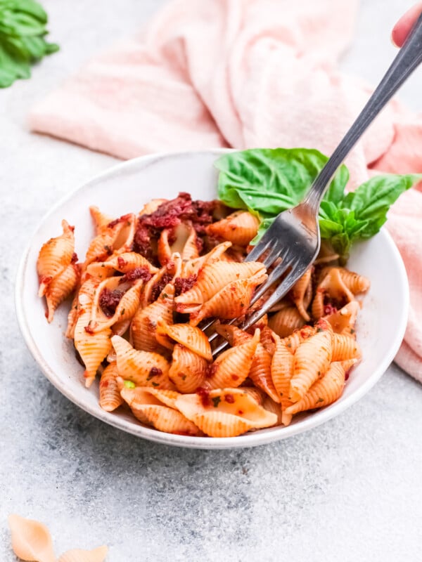 Sun-Dried Tomato Pesto Pasta with a fork in a bowl.