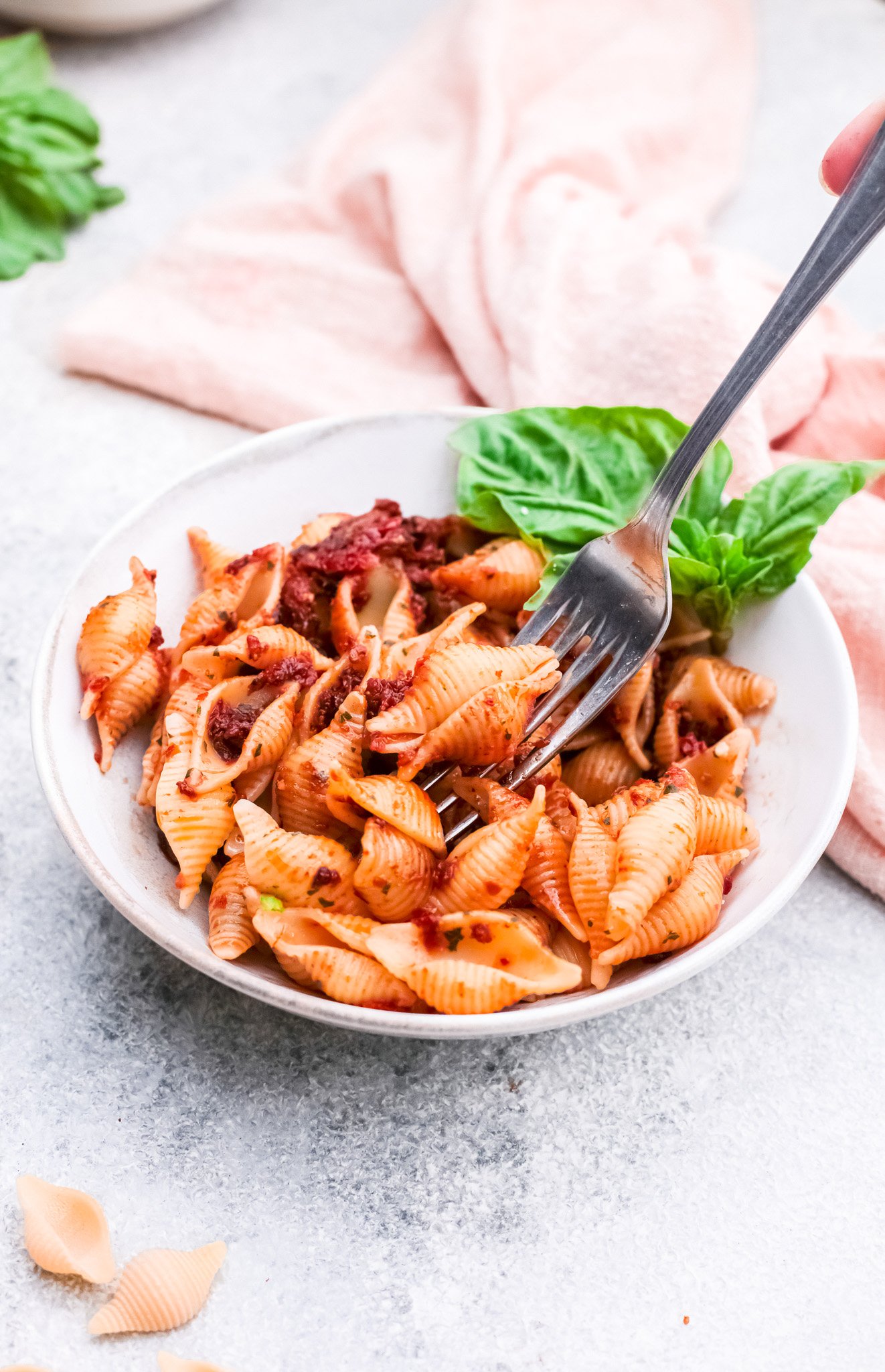 Sun-Dried Tomato Pesto Pasta with a fork in a bowl. 