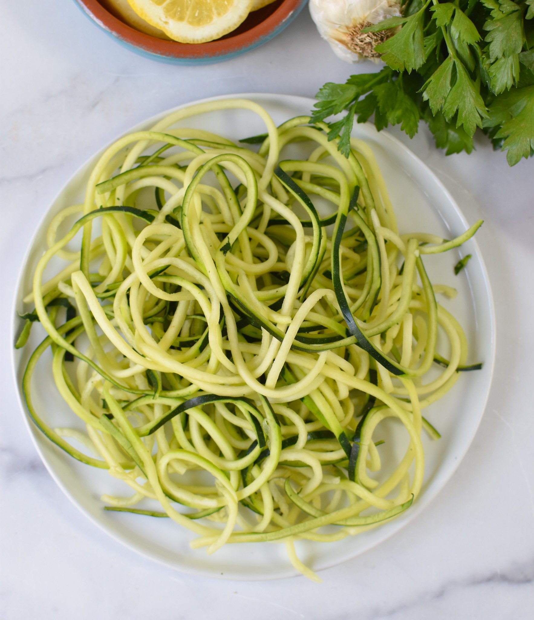 Alfredo Zoodles Recipe zucchini noodles on a plate. 