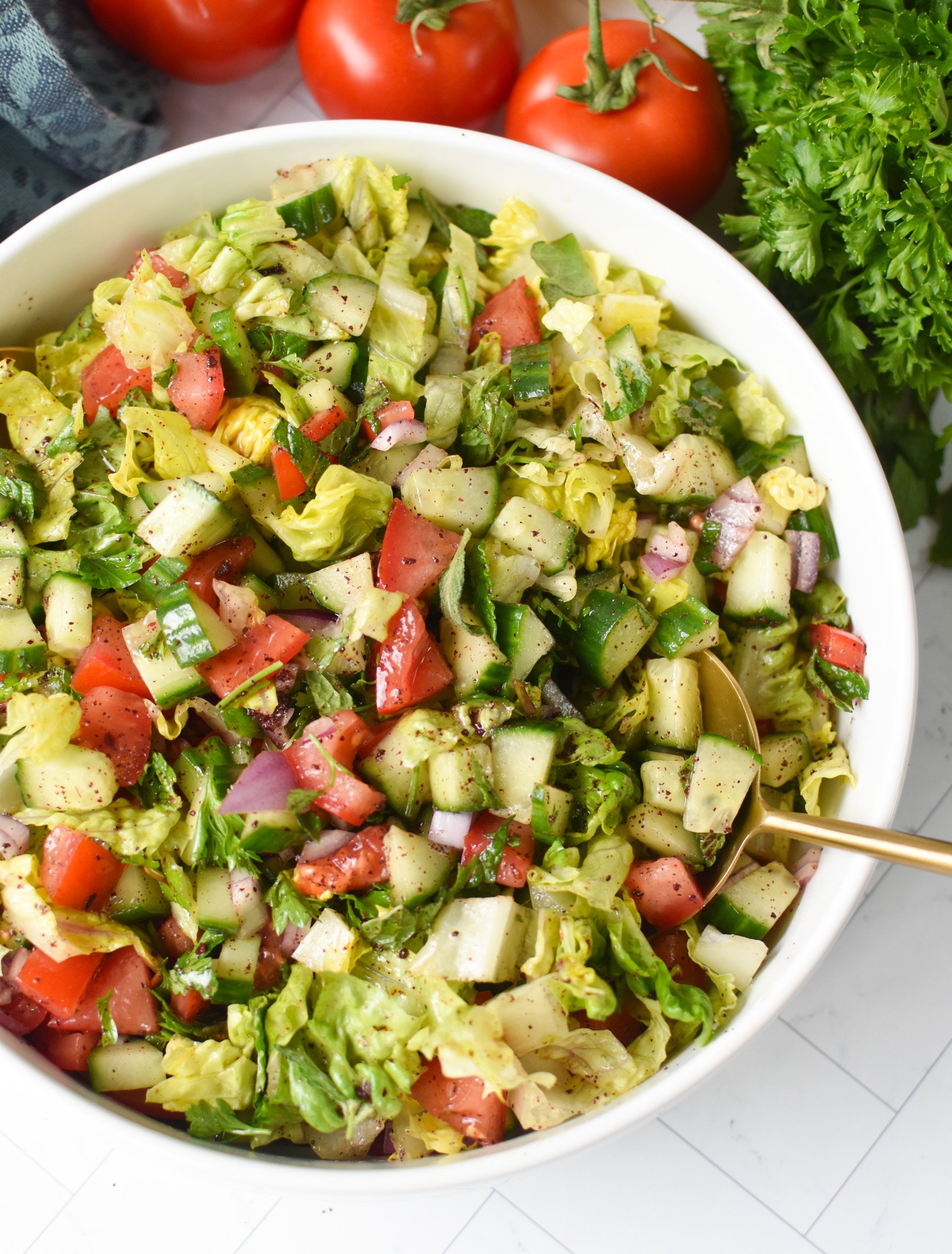 Easy Arabic Salad with a gold spoon.