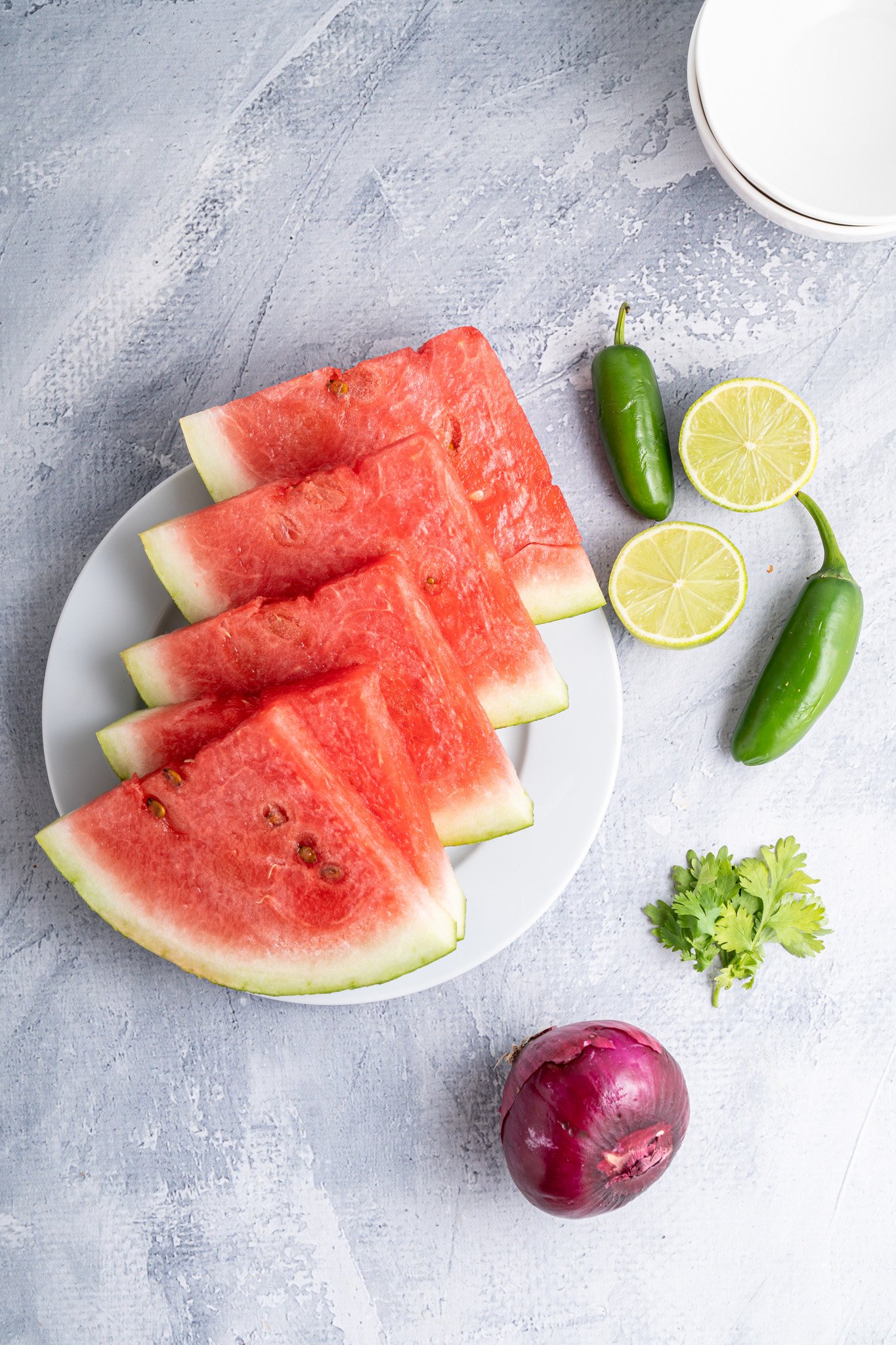 Easy Watermelon Salsa ingredients on a blue board.