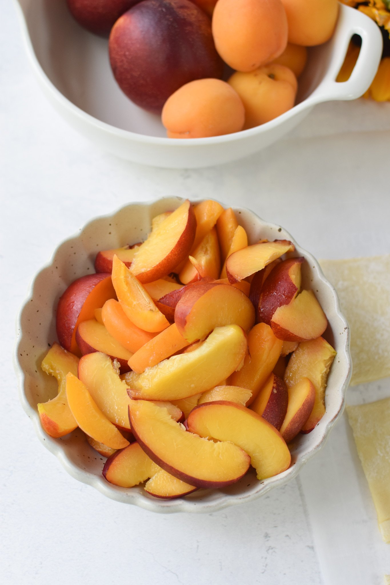Easy Peach Tart sliced nectarines in a bowl. 