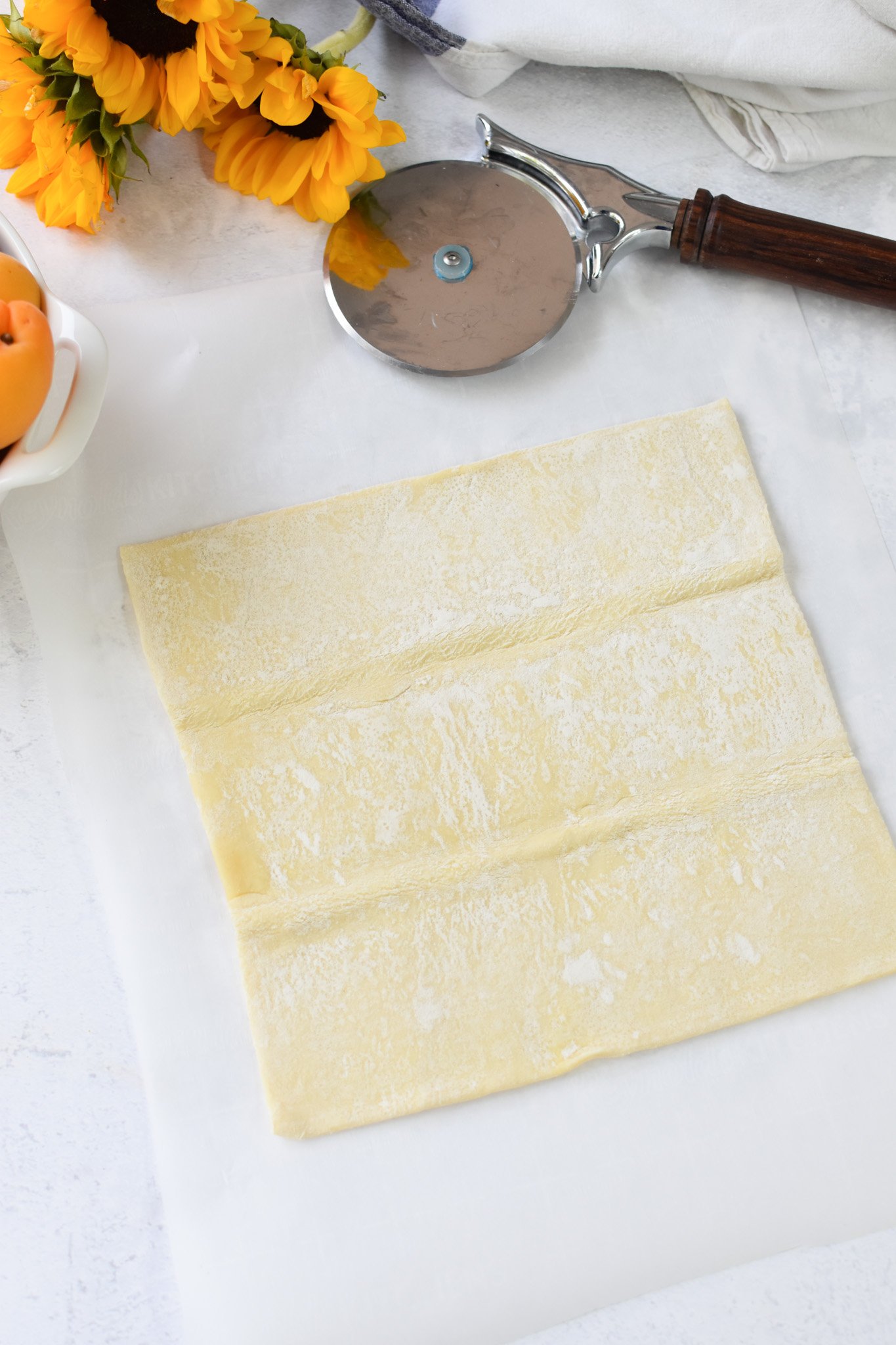 Easy Peach Tart puff pastry on parchment paper. 