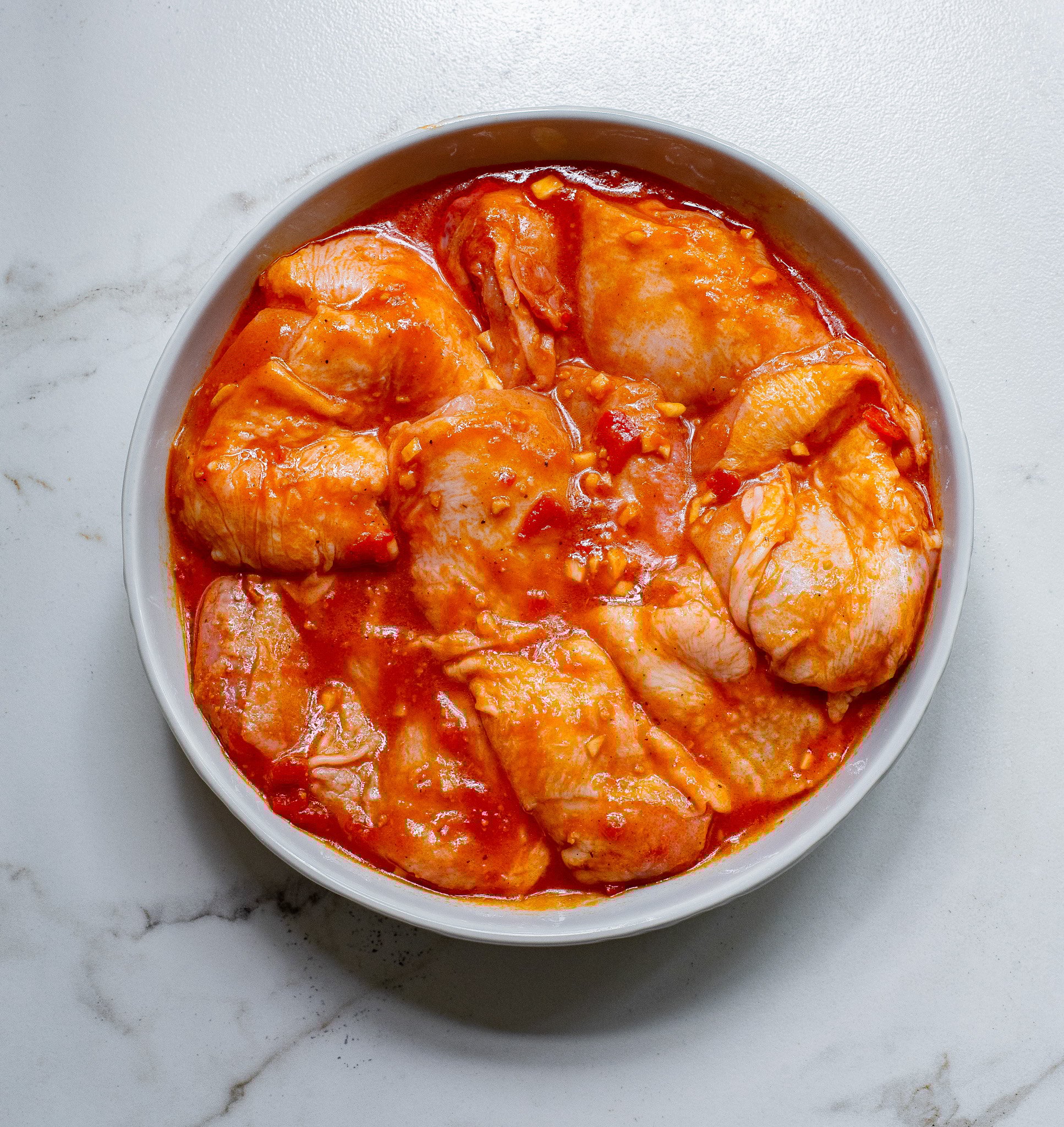 Harissa Chicken Recipe chicken with a marinade. 