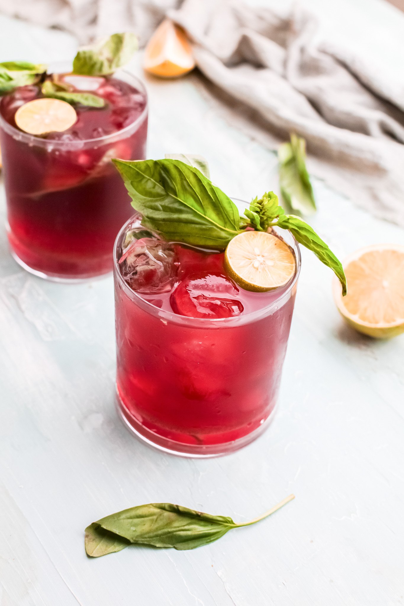 Vodka Cherry Limeade in a glade with basil.