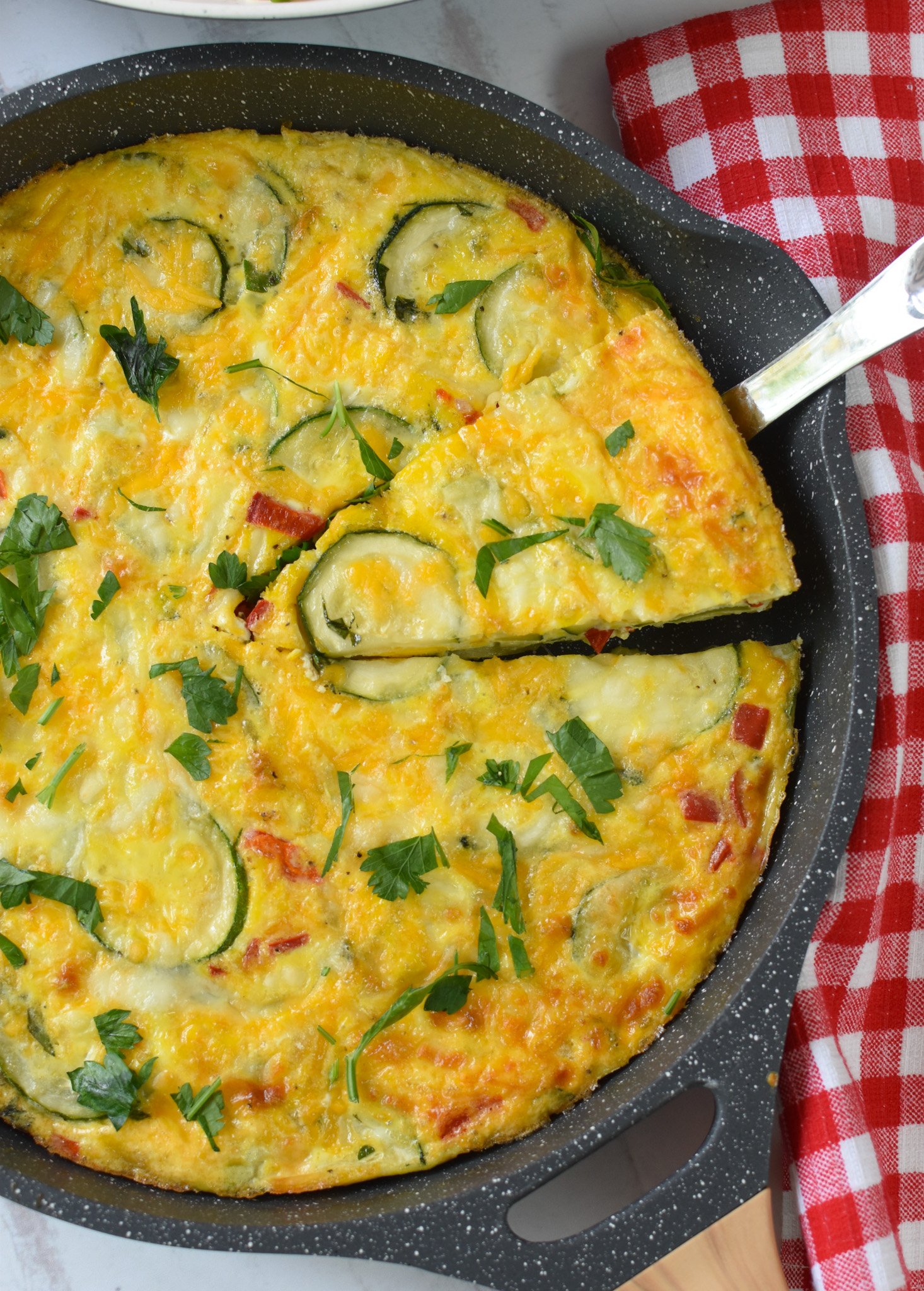 Zucchini Frittata Recipe with a pie cutter.