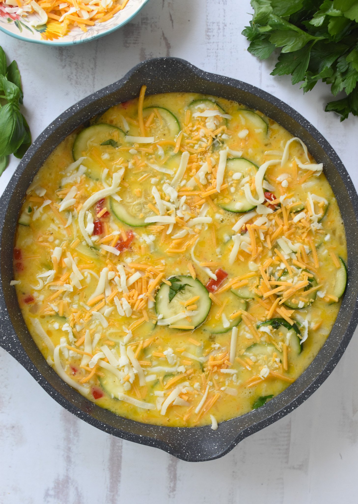 Zucchini Frittata Recipe with cheese on the eggs.