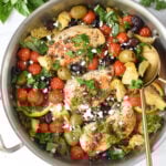 Mediterranean Skillet Chicken in a skillet with fork and spoon.