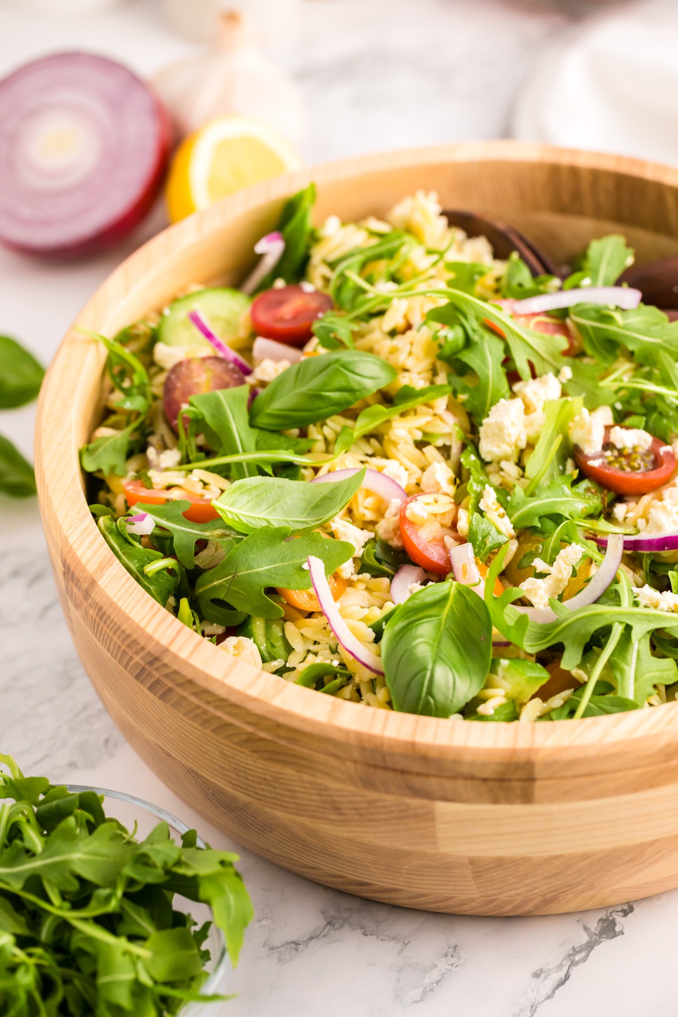Arugula Orzo Salad in a wooden bowl.