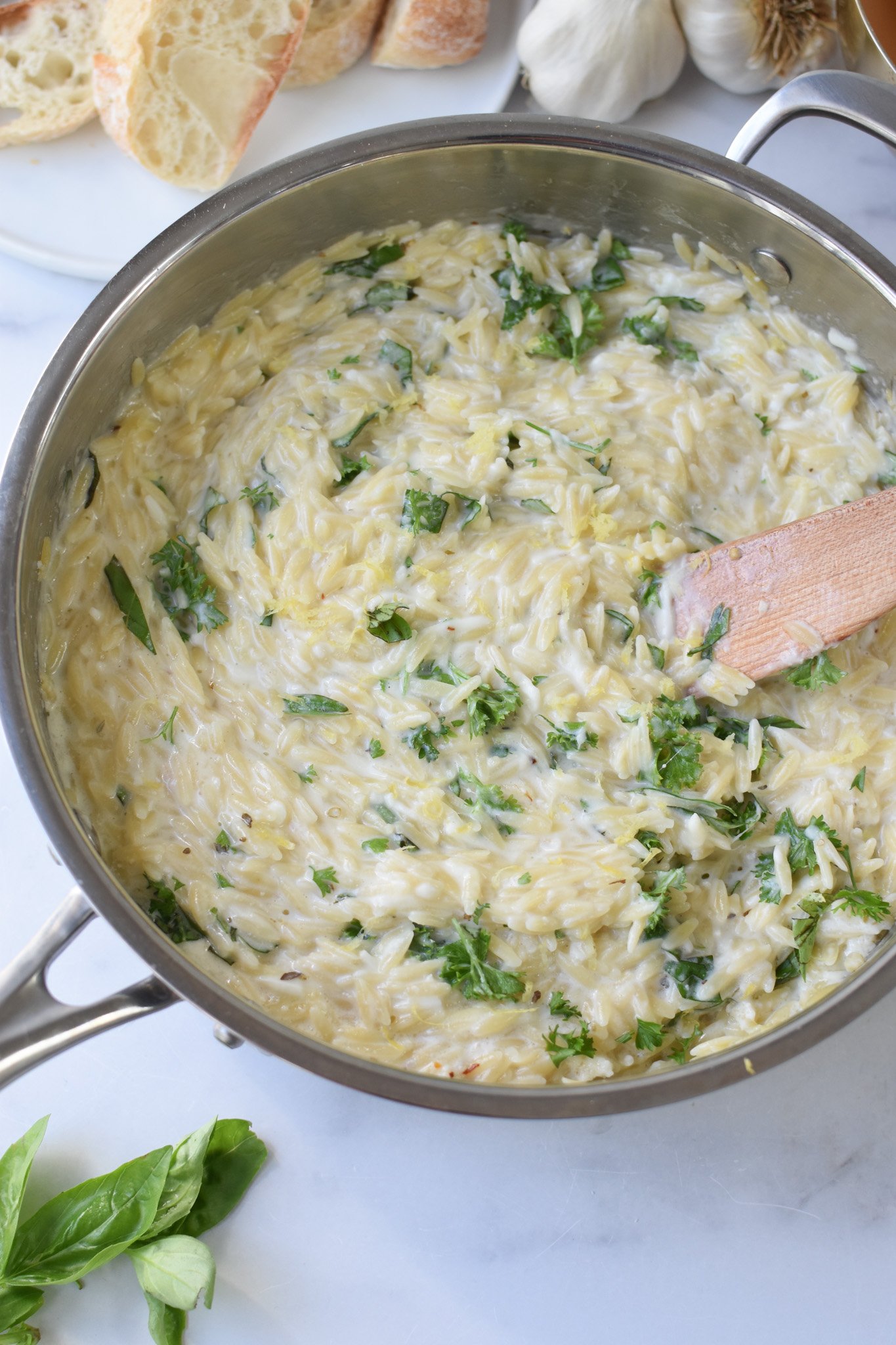 Lemon Chicken Orzo with wooden serving spoon.