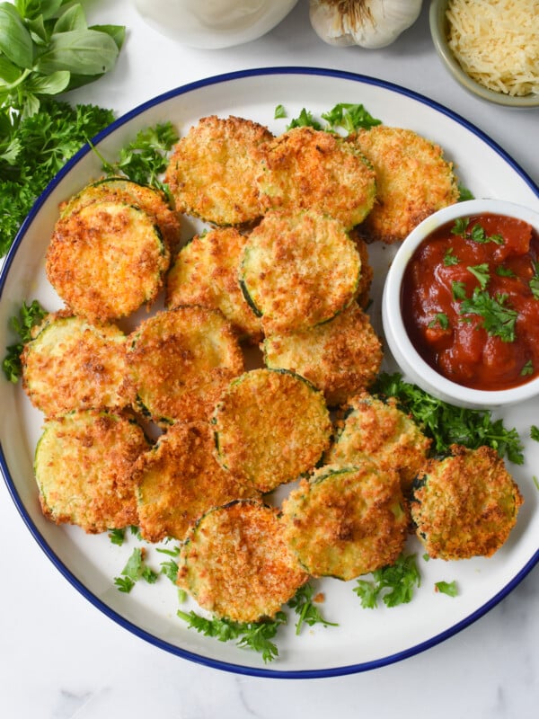 Air Fryer Zucchini Chips on a white plate.