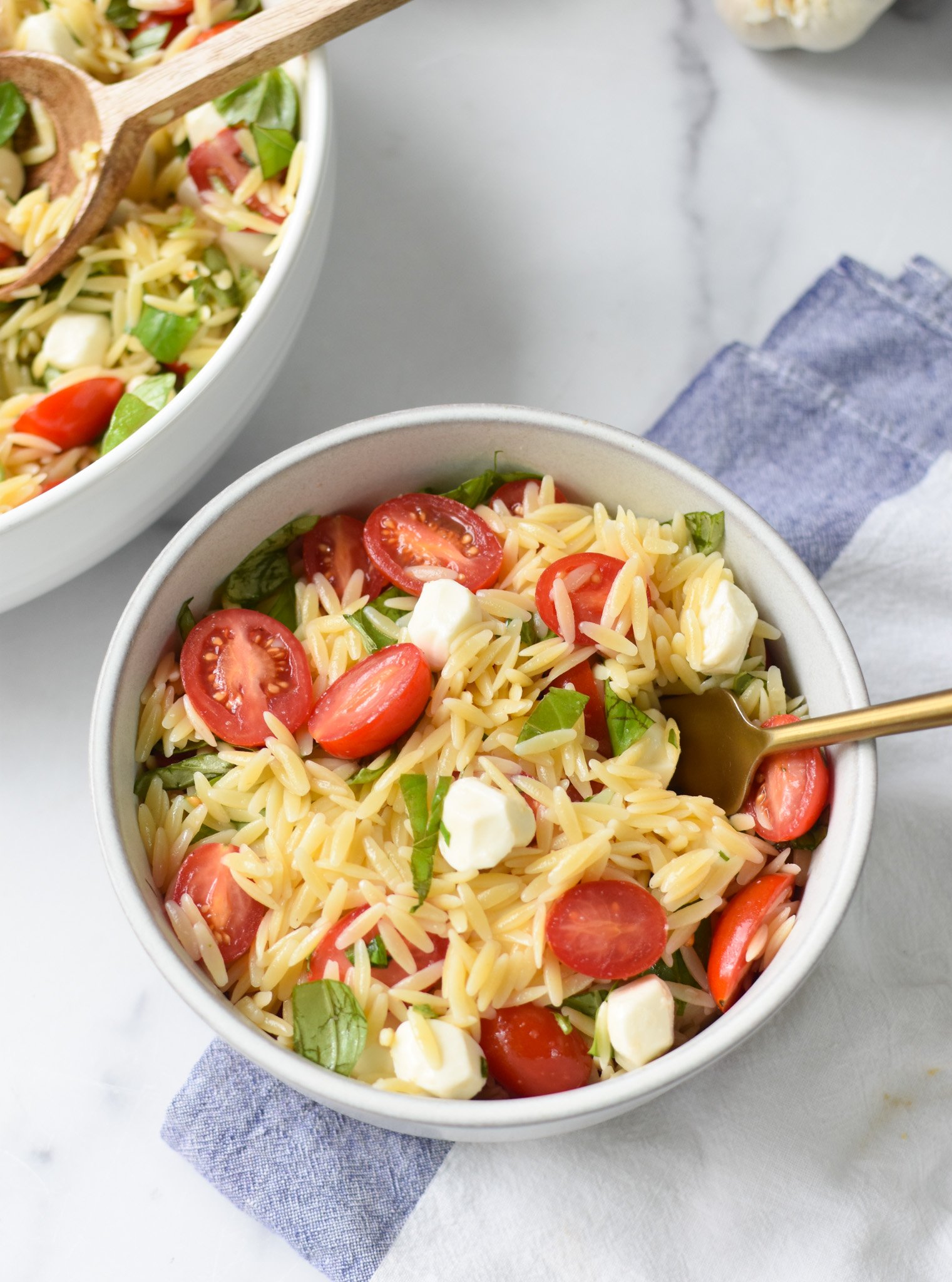 Caprese Orzo Pasta Salad with fork. 