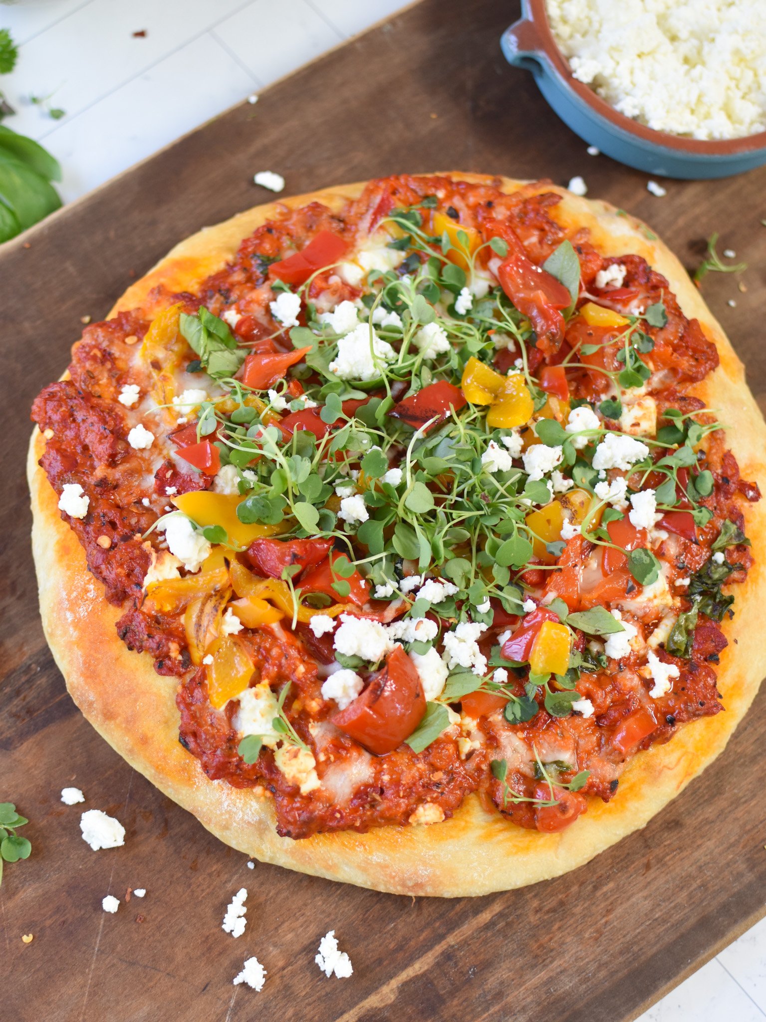 Cast Iron Mediterranean Pizza on a cutting board. 