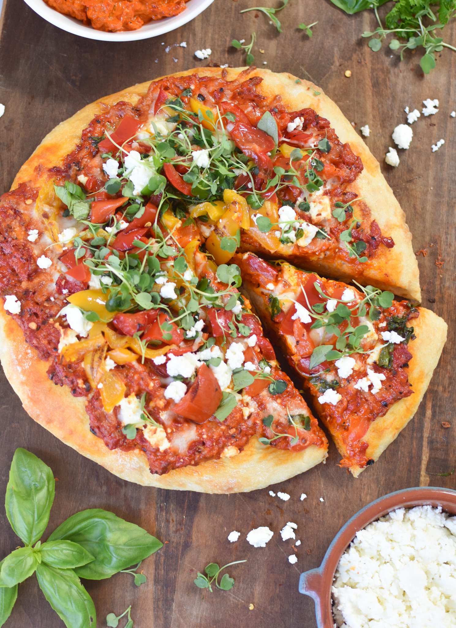 Cast Iron Mediterranean Pizza with a slice of pizza.
