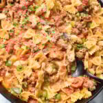 Creamy Chicken and Chorizo Pasta Recipe with black spoon.