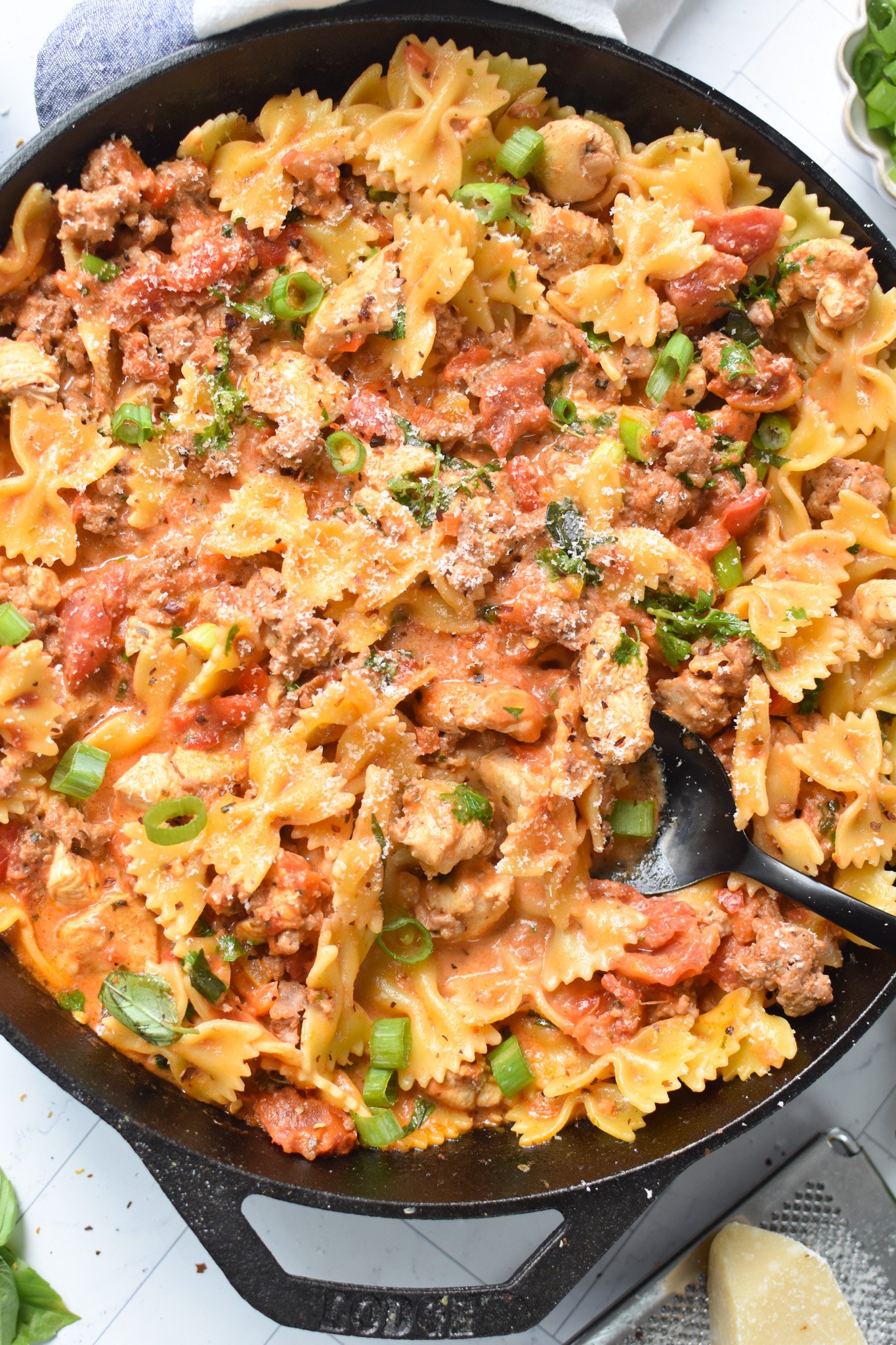 Creamy Chicken and Chorizo Pasta Recipe with black spoon.