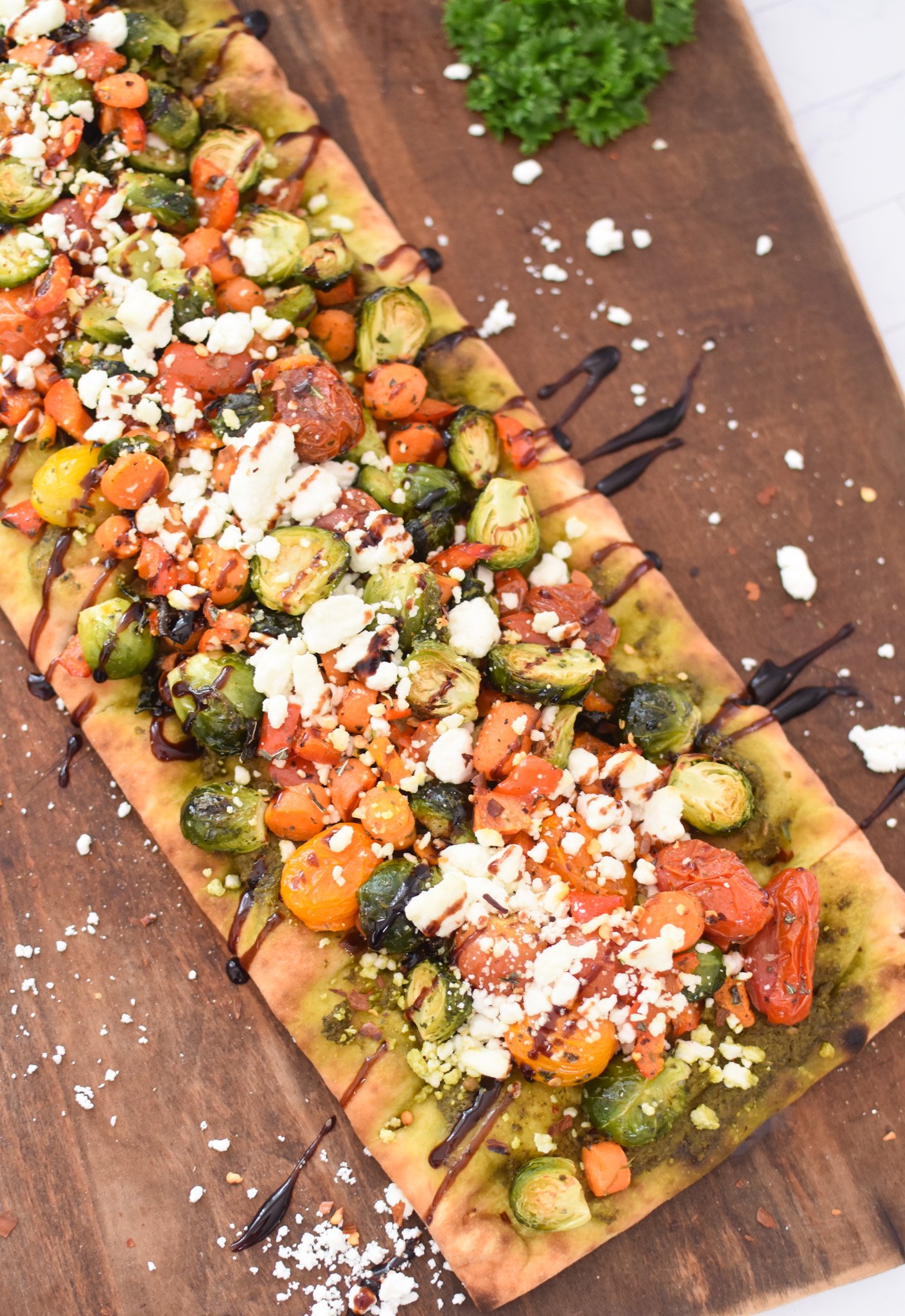 Roasted Vegetable Goat Cheese Flatbread Pizza Recipe on a cutting board. 
