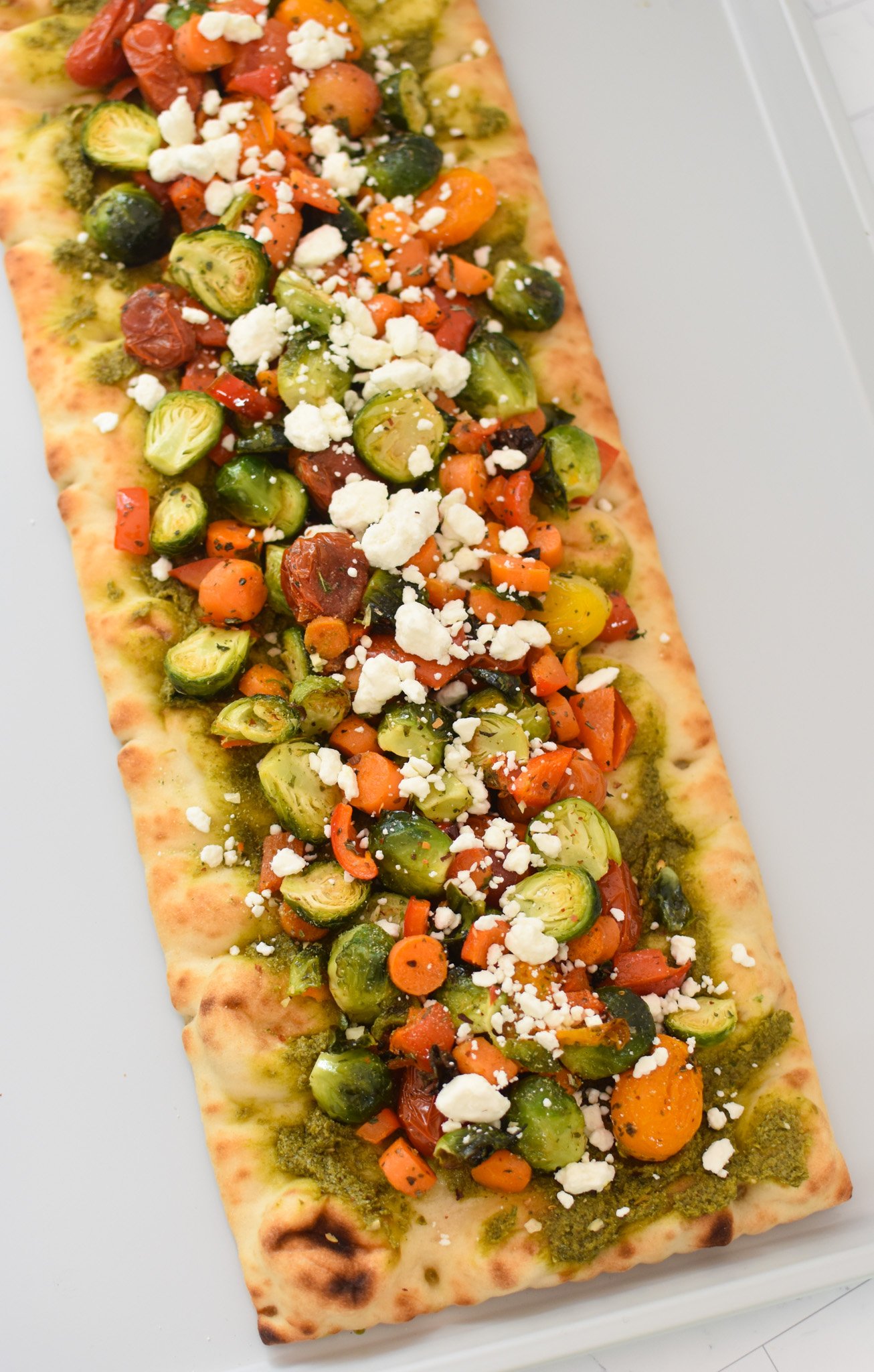 Roasted Vegetable Goat Cheese Flatbread Pizza Recipe on baking sheet. 