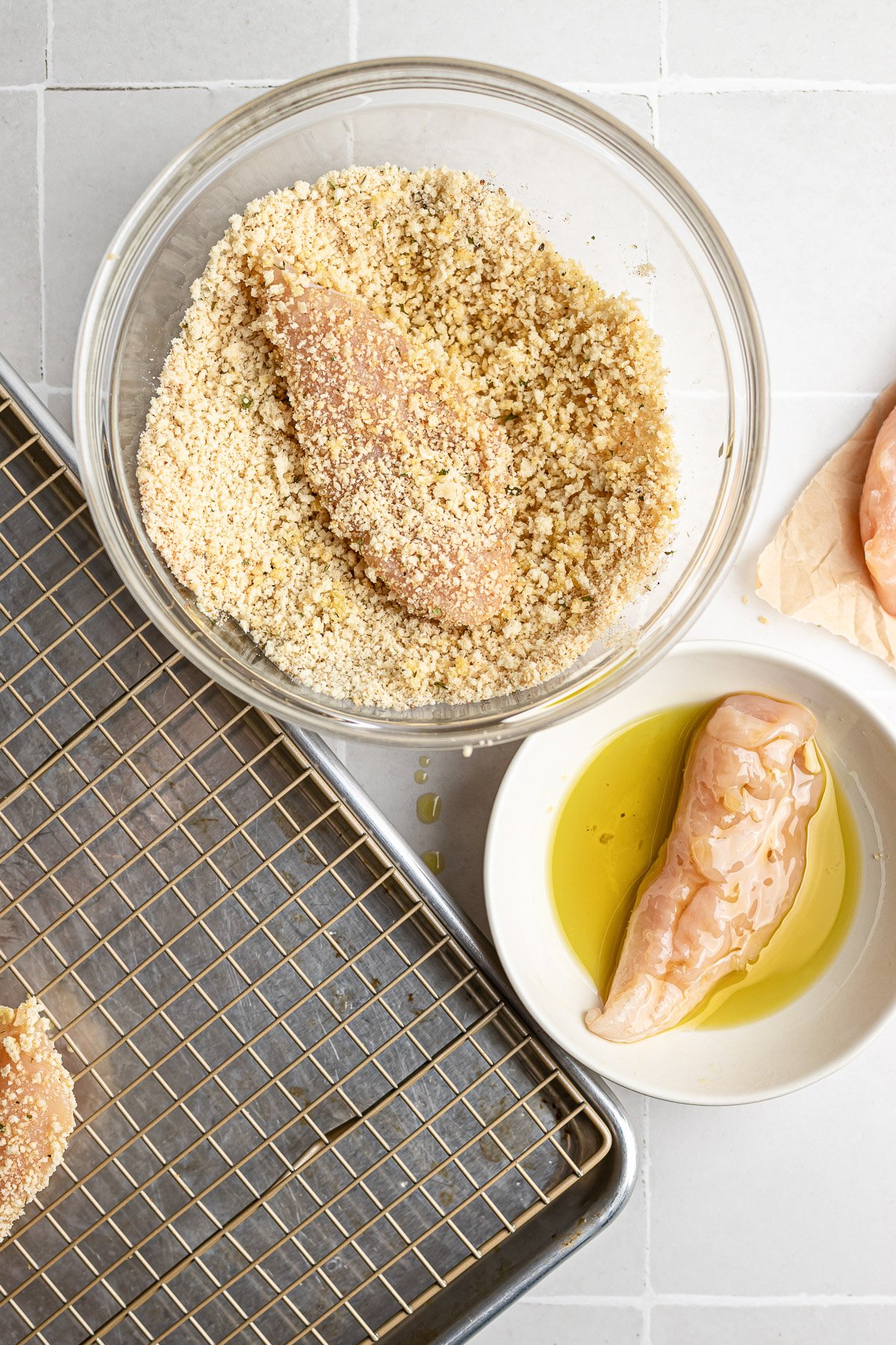 step 2 – dredging chicken tenders in olive oil before coating