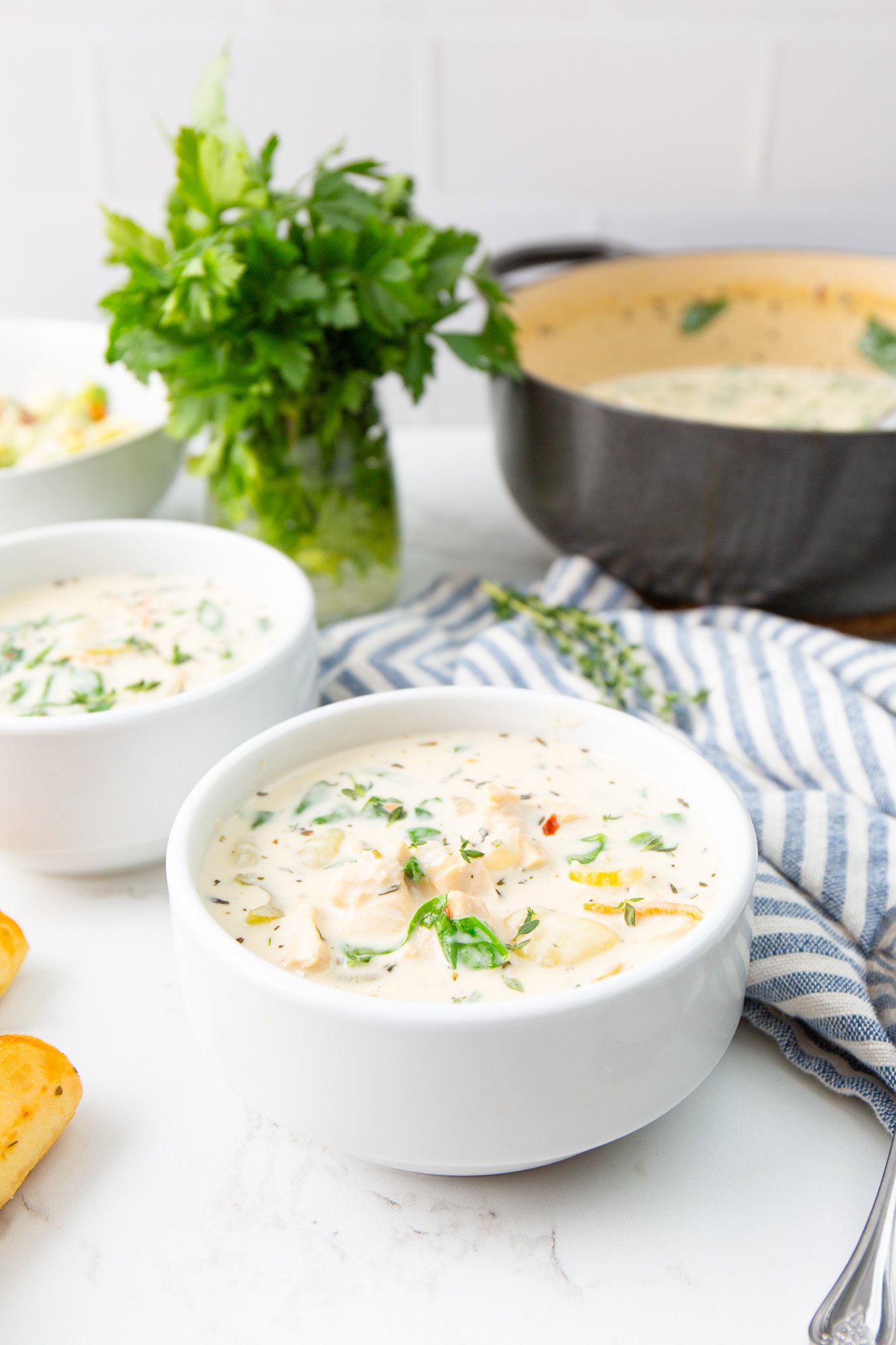 Copycat Olive Garden Chicken Gnocchi Soup Recipe two bowls of soup with the dutch oven.