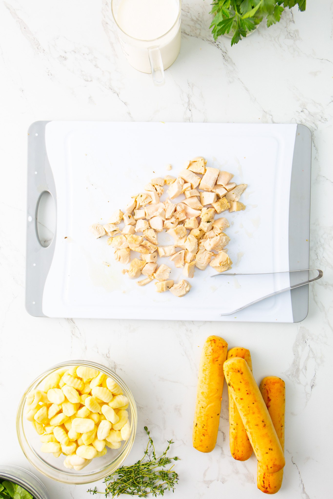 Copycat Olive Garden Chicken Gnocchi Soup Recipe chicken being shredded. 