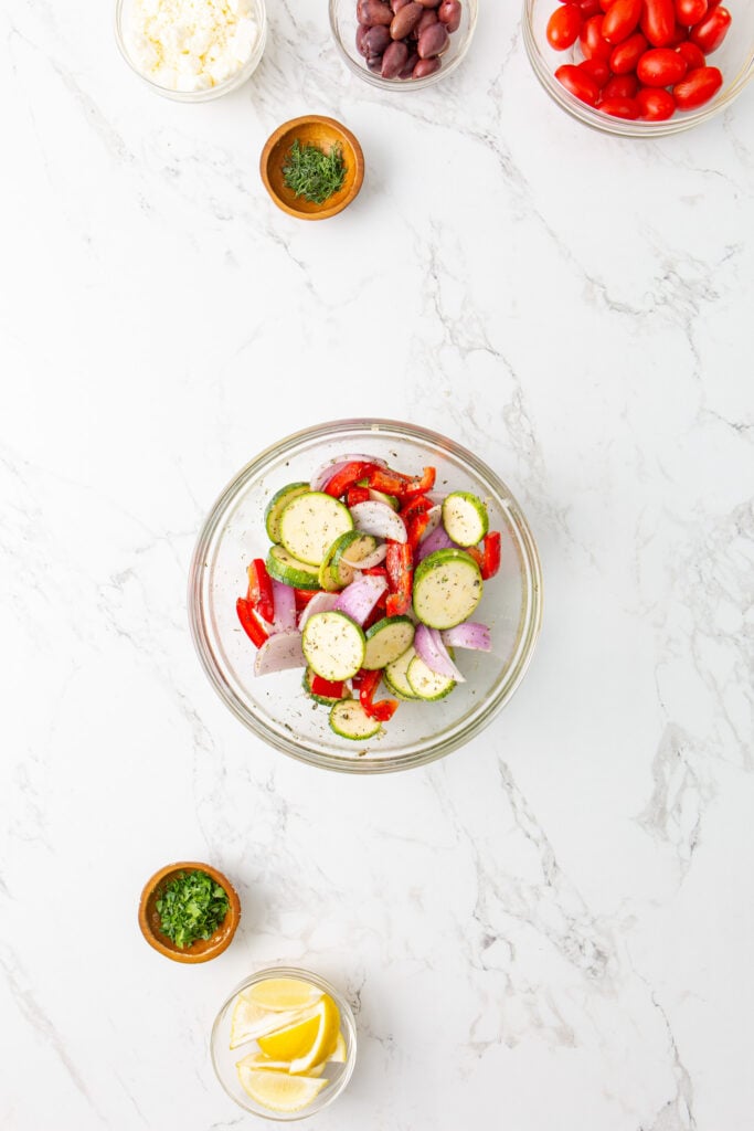 Mediterranean Sheet Pan Chicken vegetables in marinade.