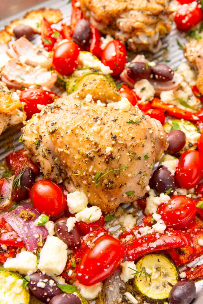 Mediterranean Sheet Pan Chicken on a sheet pan with feta cheese