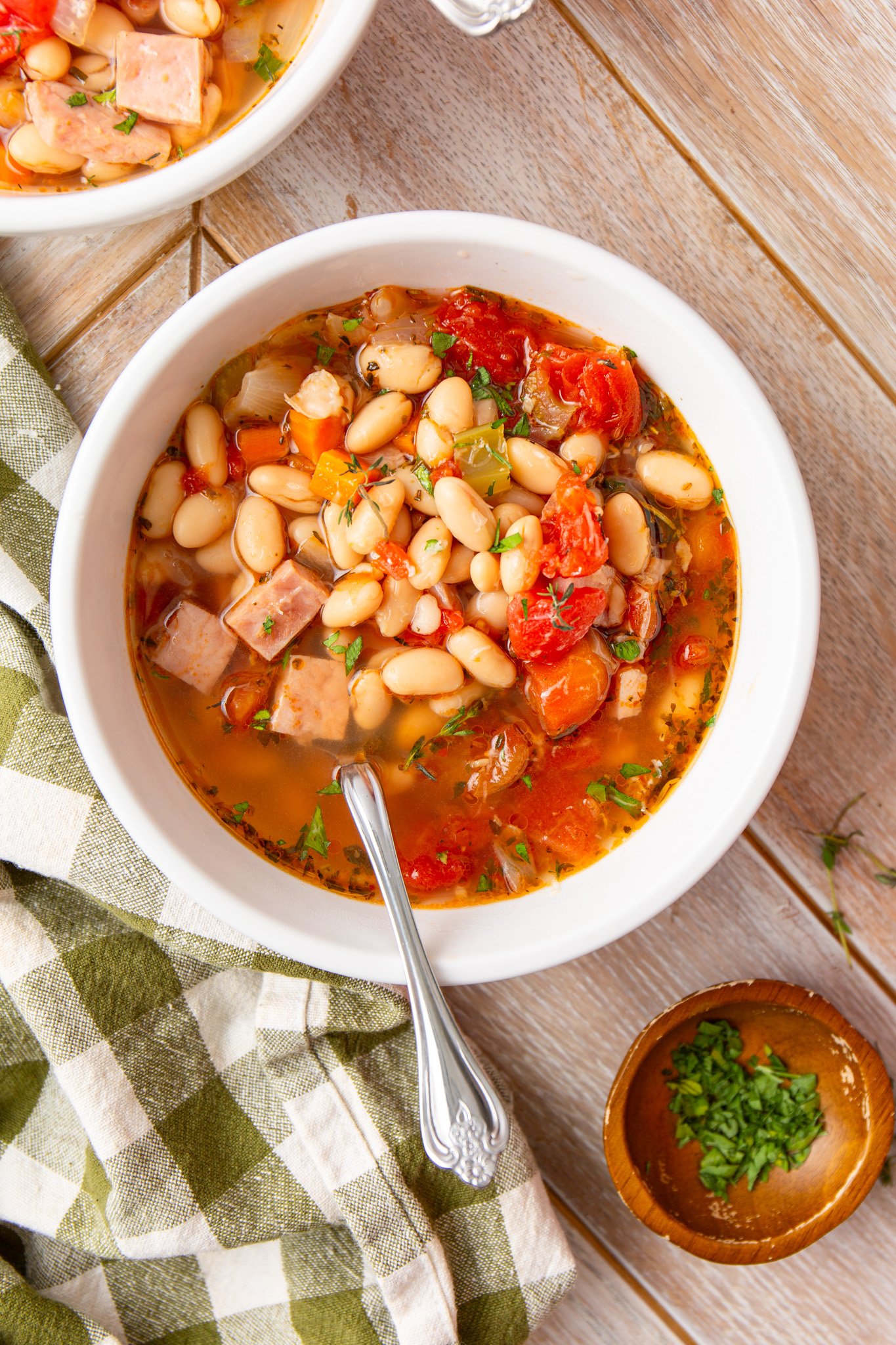 Navy Bean Soup Recipe with a spoon in a white bowl
