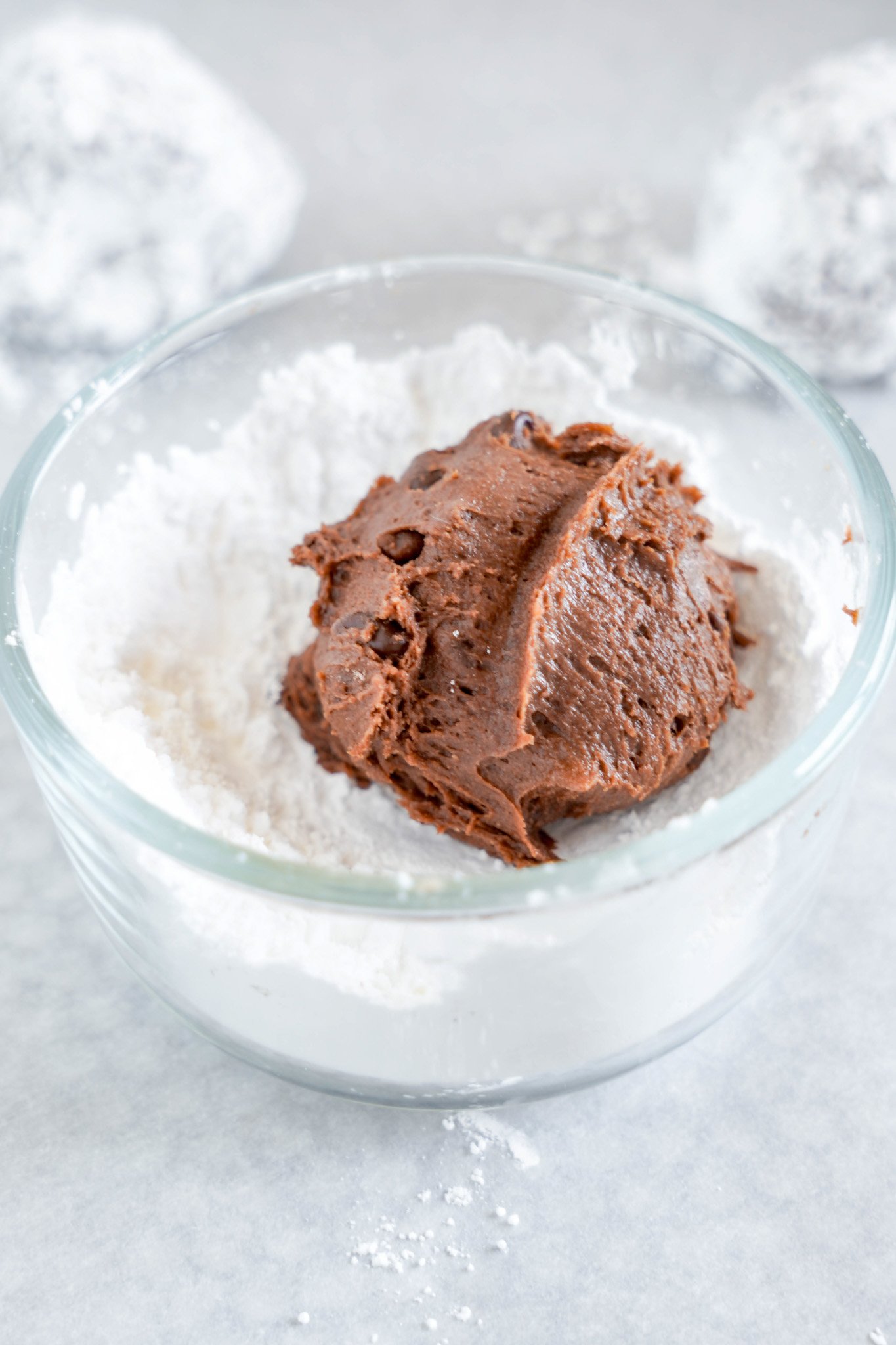 Chocolate Crinkle Cookie Recipe dough in powdered sugar. 