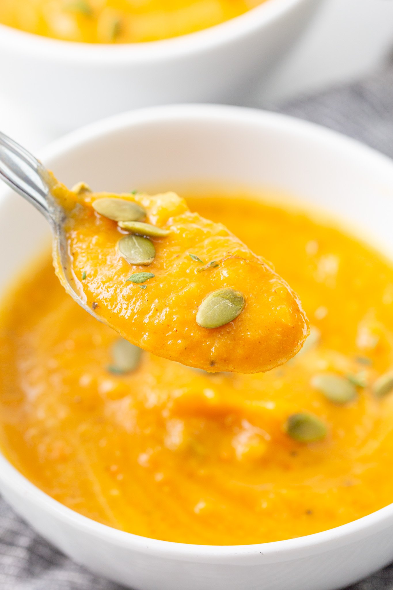 Easy Roasted Butternut Squash Soup pureed soup on spoon. 