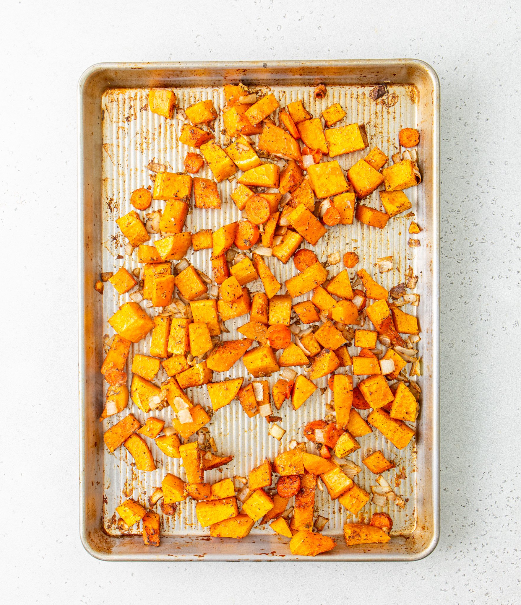 Easy Roasted Butternut Squash Soup roasting on a tray. 
