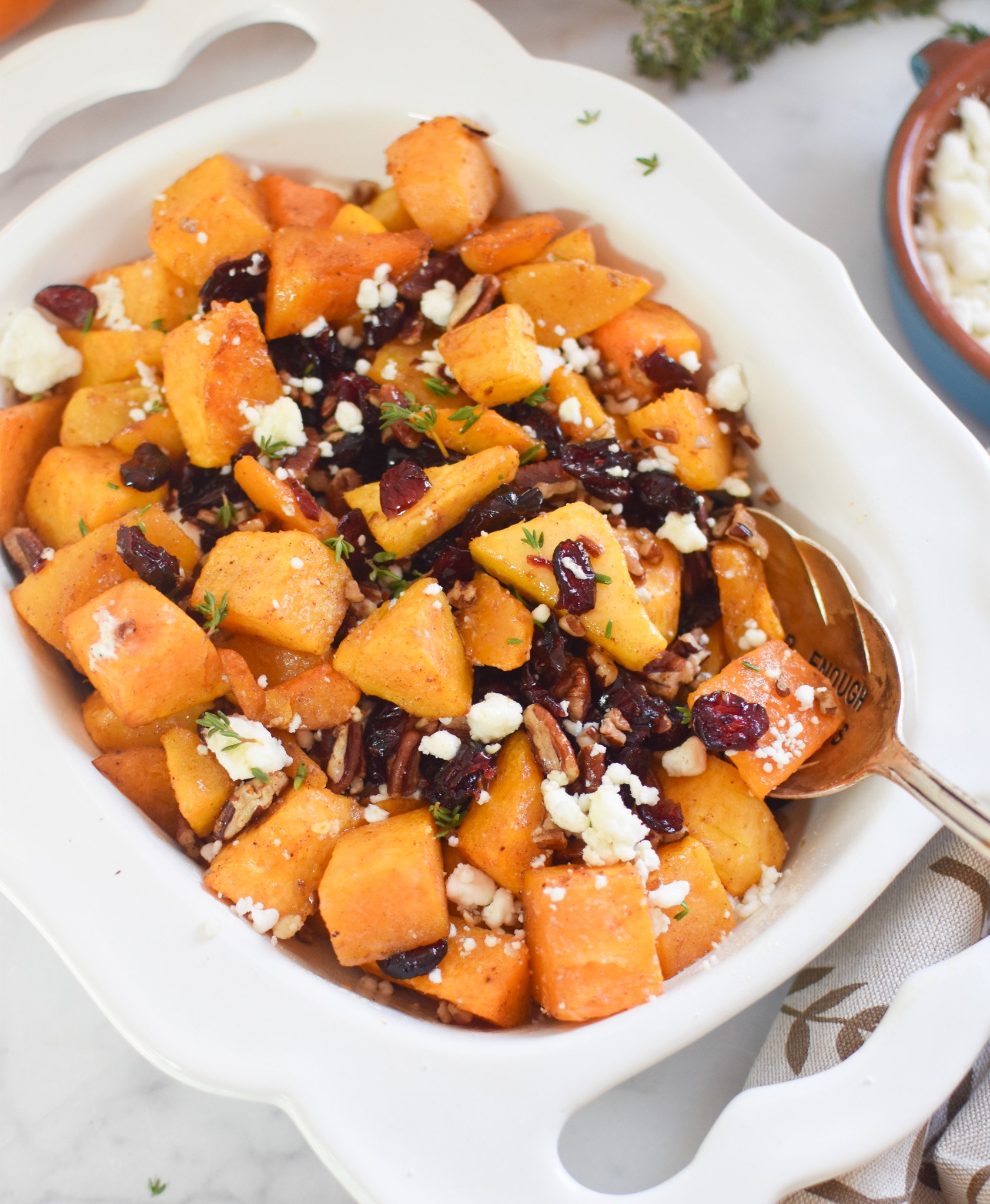Roasted Butternut Squash with Cranberries in white bowl 