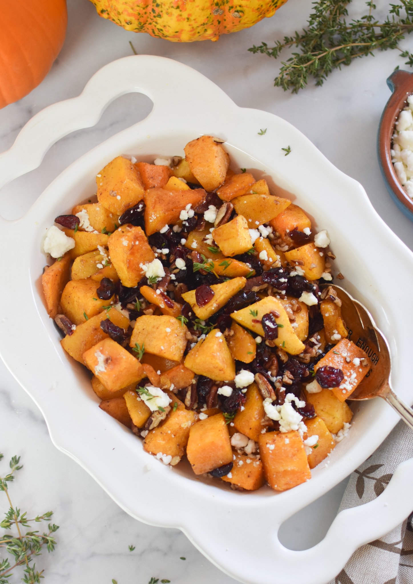 Roasted Butternut Squash with Cranberries in white bowl 